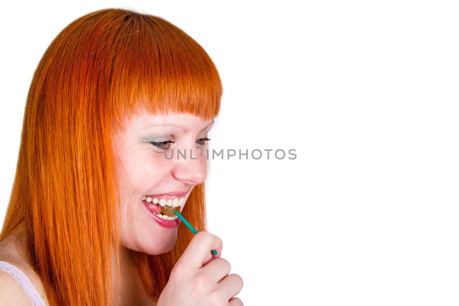 Young pretty woman with lollipop on her lips. Isolated over white background.