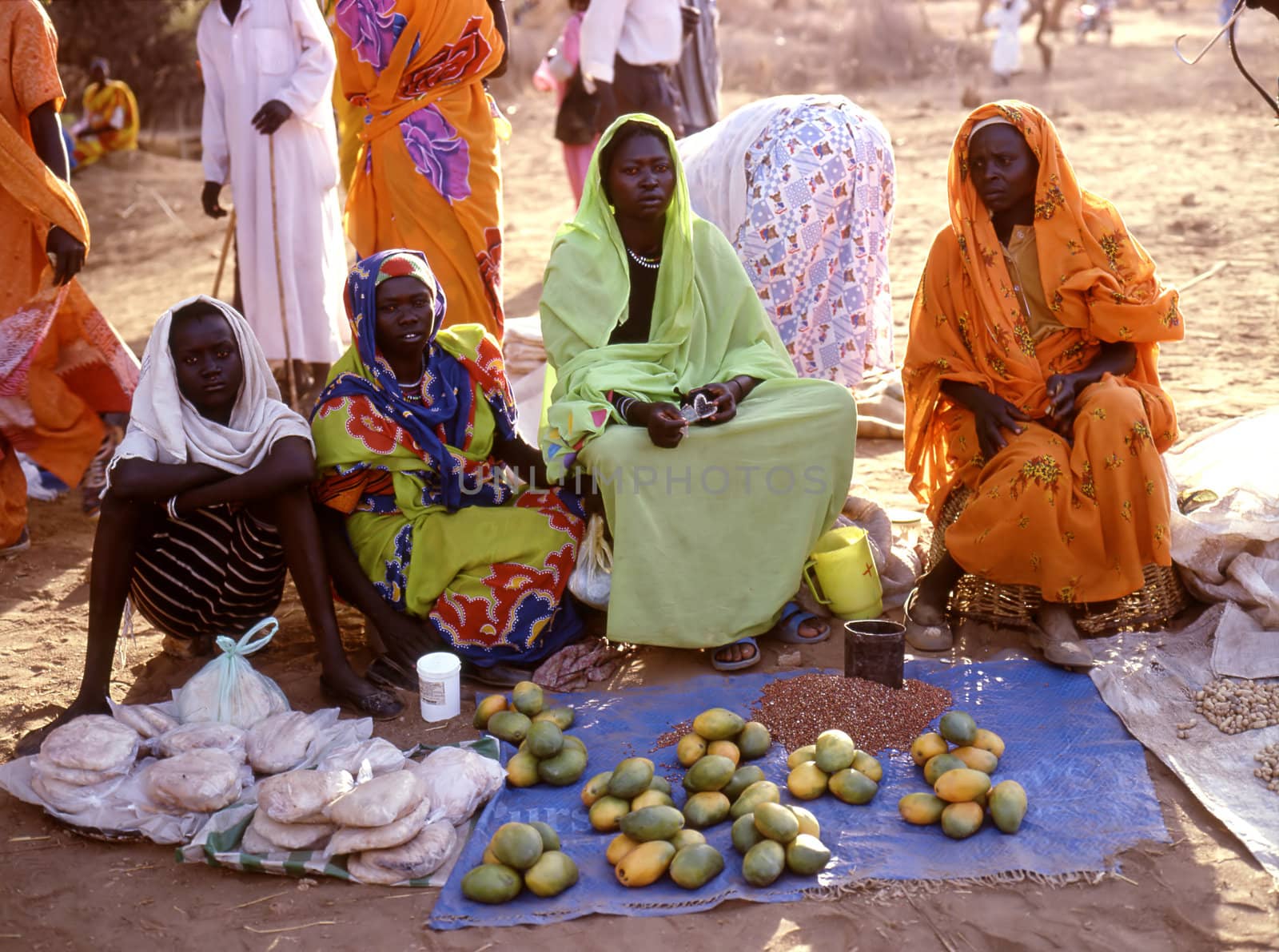 Nuba Mountains, Sudan, September 7,2008: women in the market selling papaya. A small market in the Nuba Mountains
