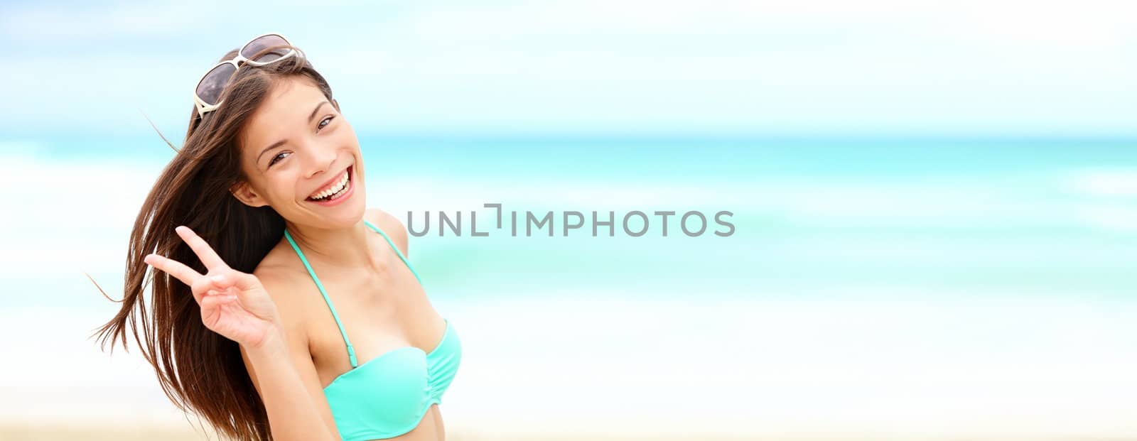 Summer vacation banner. Happy beautiful woman on beach in bikini smiling joyful with panorama for copy space.