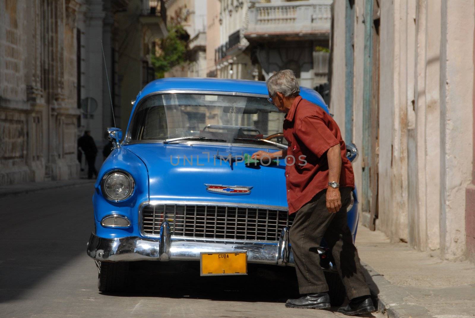 La Habana, Cuba - February 8, 2009: A Cuban cleans its magnificent old American cars. In Cuba there are many old American car collection