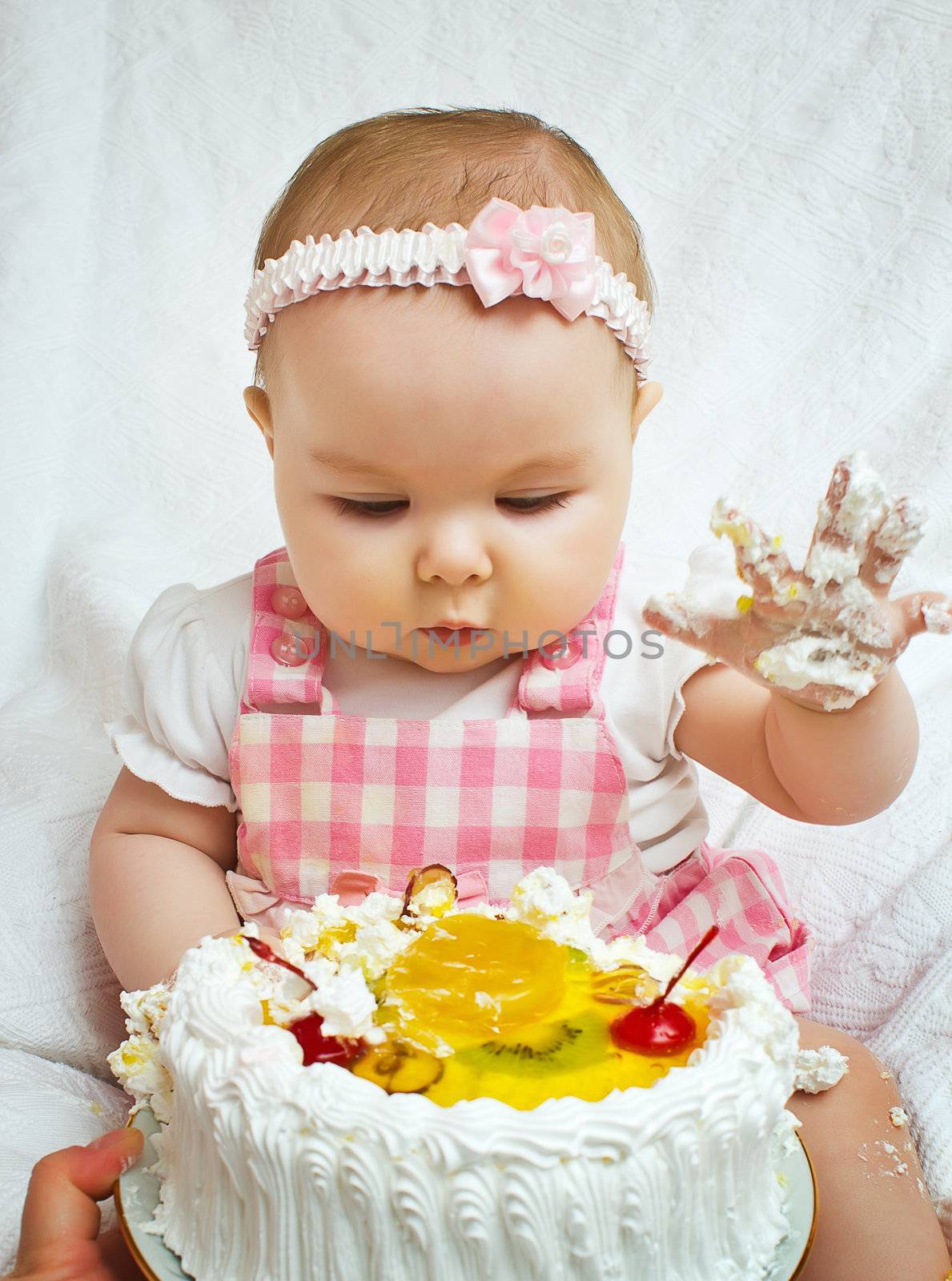 Little girl with a sweet cake by oleg_zhukov