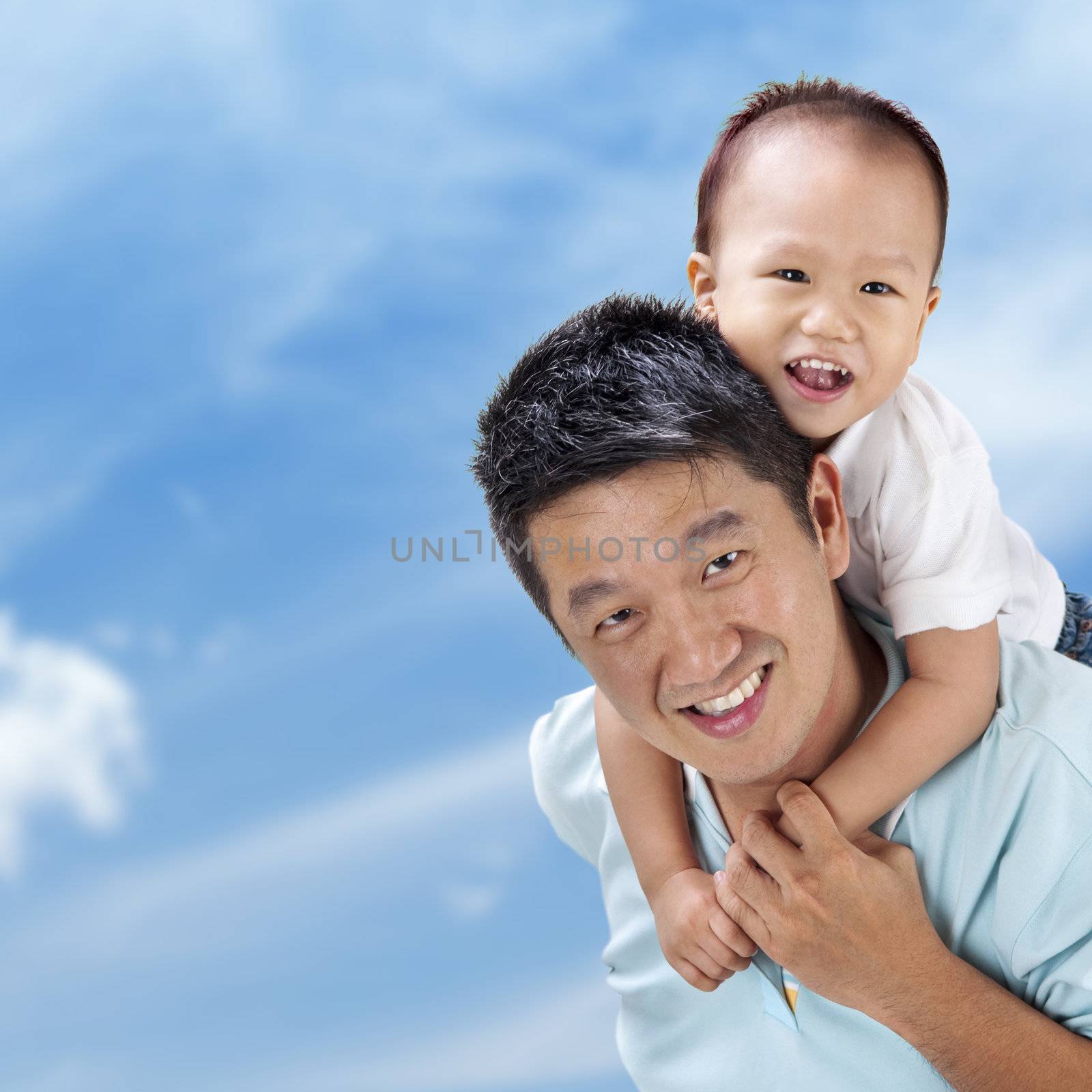 Outdoor Asian family over blue sky