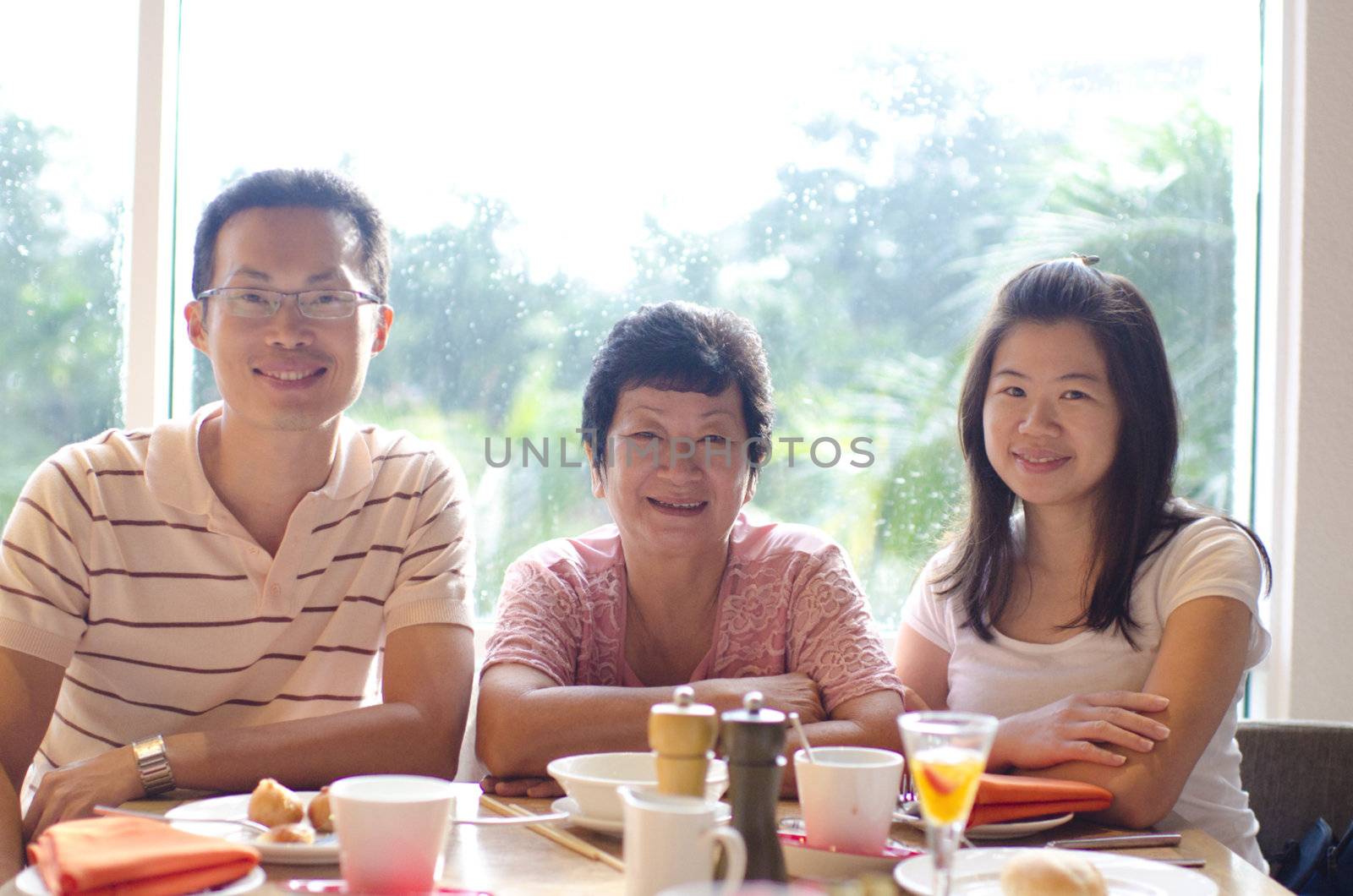 Happy Asian family dining at restaurant