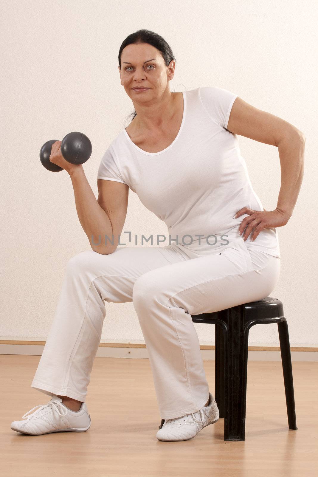 Woman over forty, sitting on a training exercise