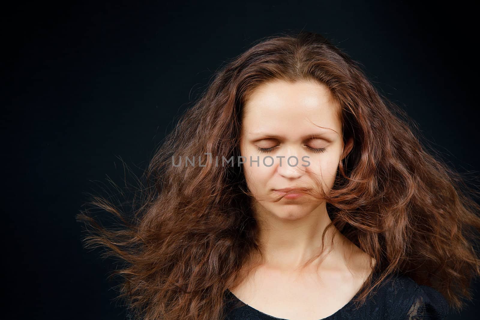 attractive girl with closed eyes and flowing long hair