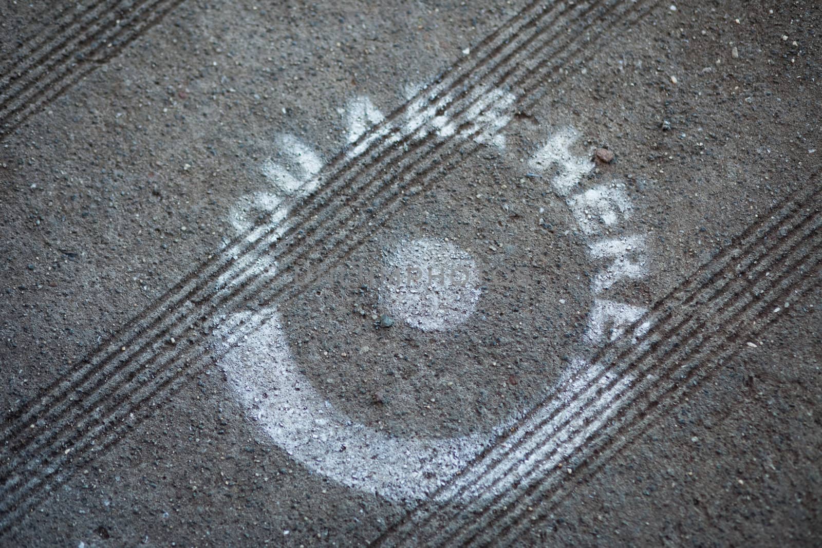 A "You Are Here" dot spray-painted on the pavement