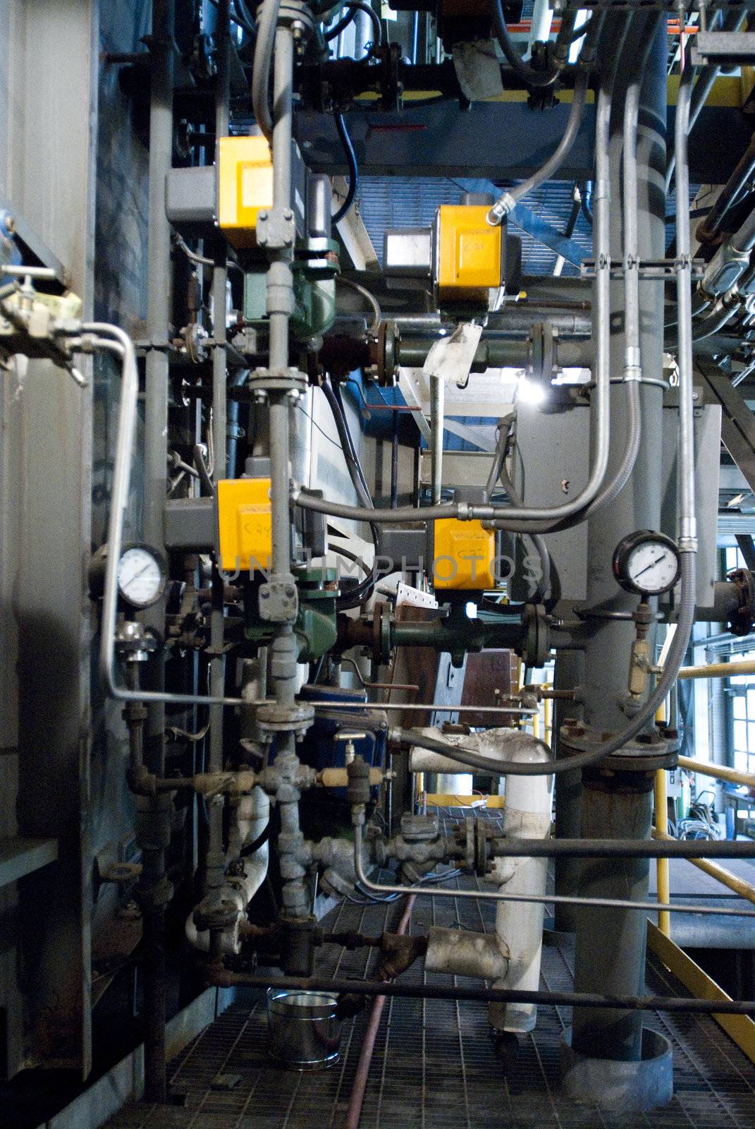 Maze of Pipes and Valves Inside Industrial Facility