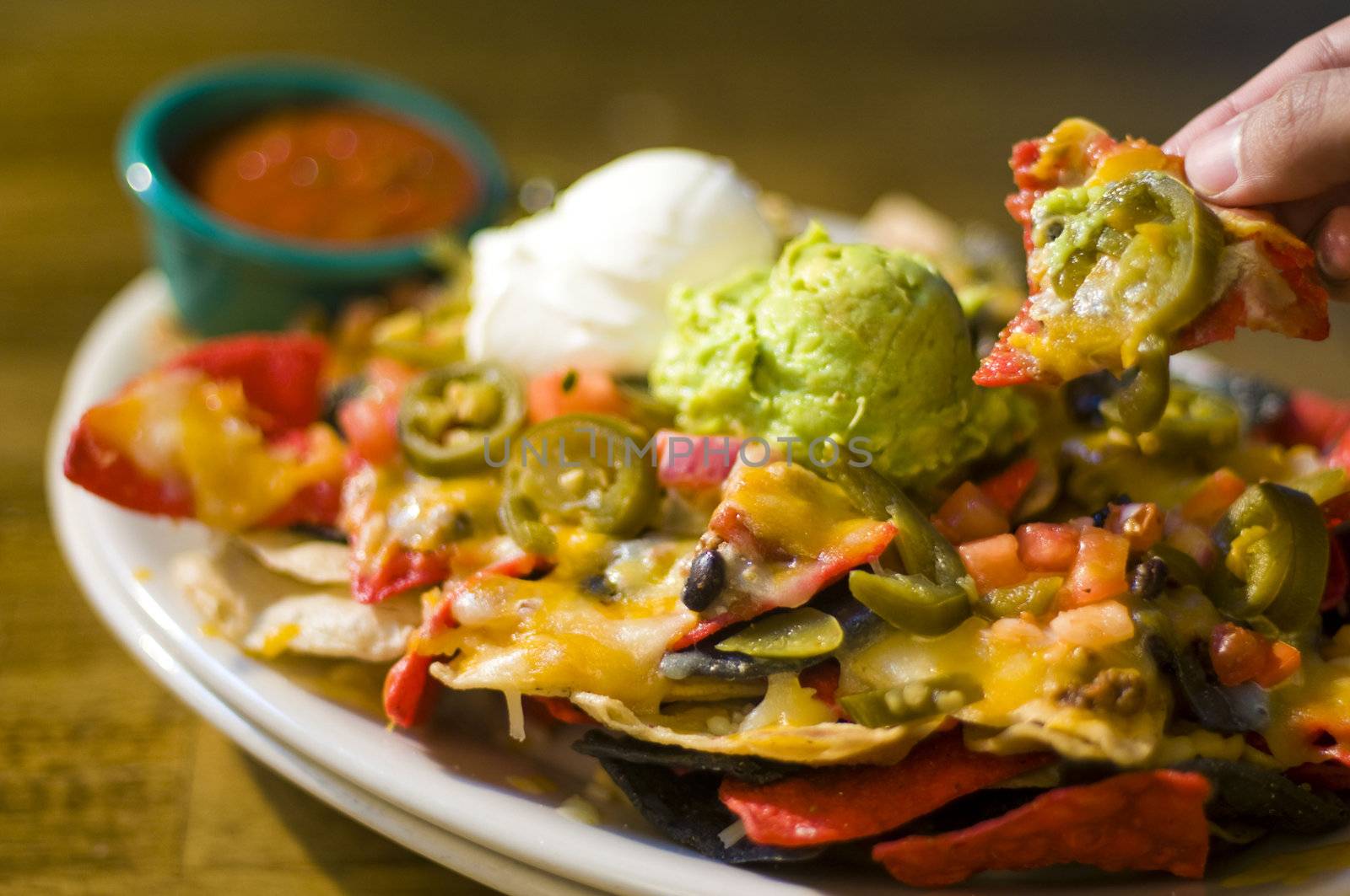 Nachos with cheese, guacamole, and sour cream