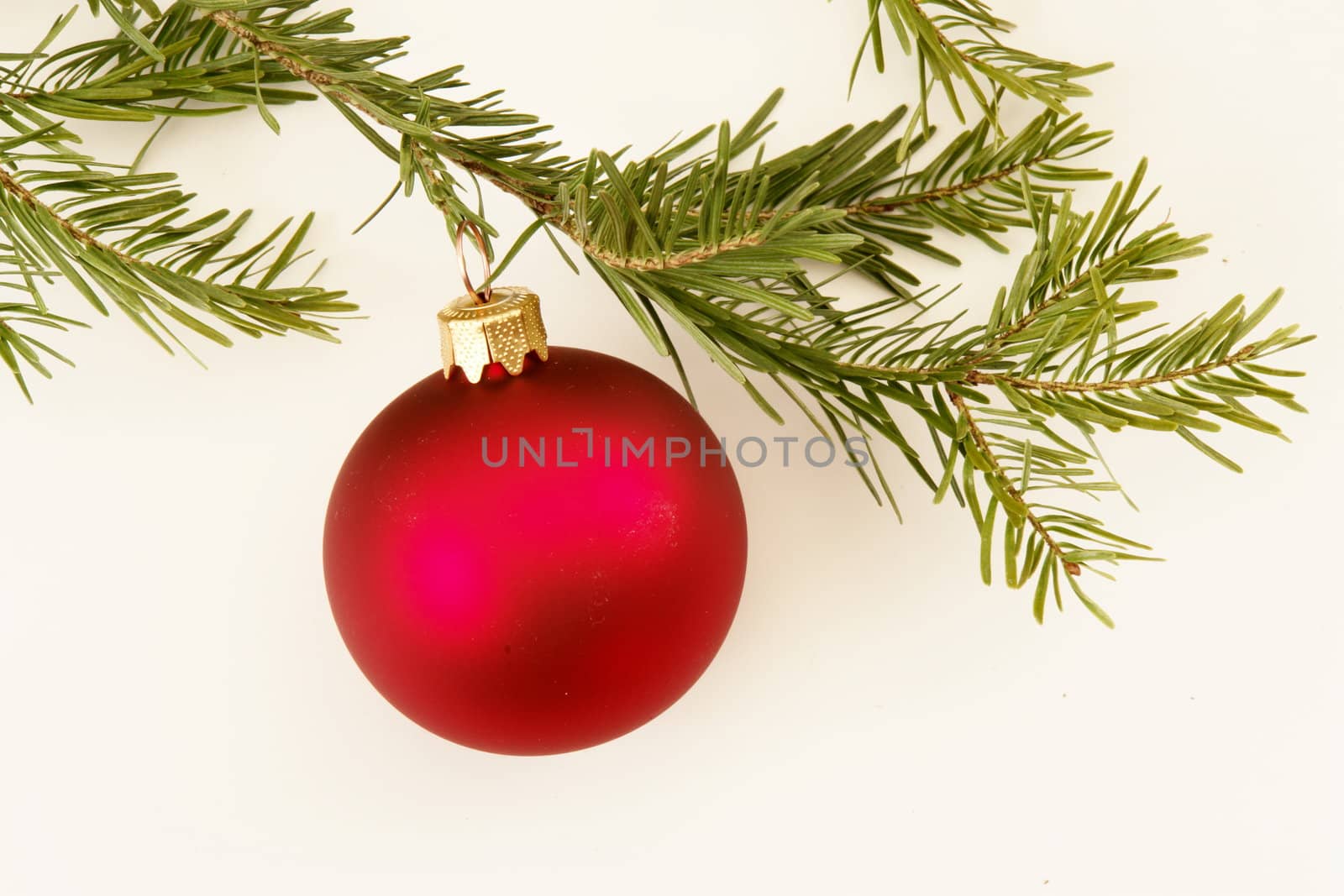 Border of red christmas garland with baubles and ribbons on white.