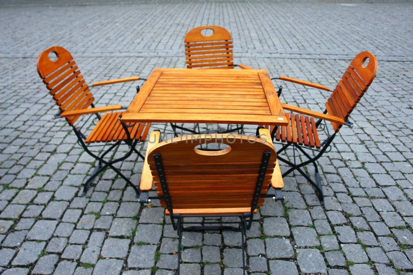 Picture of some wooden seats and tables outside..