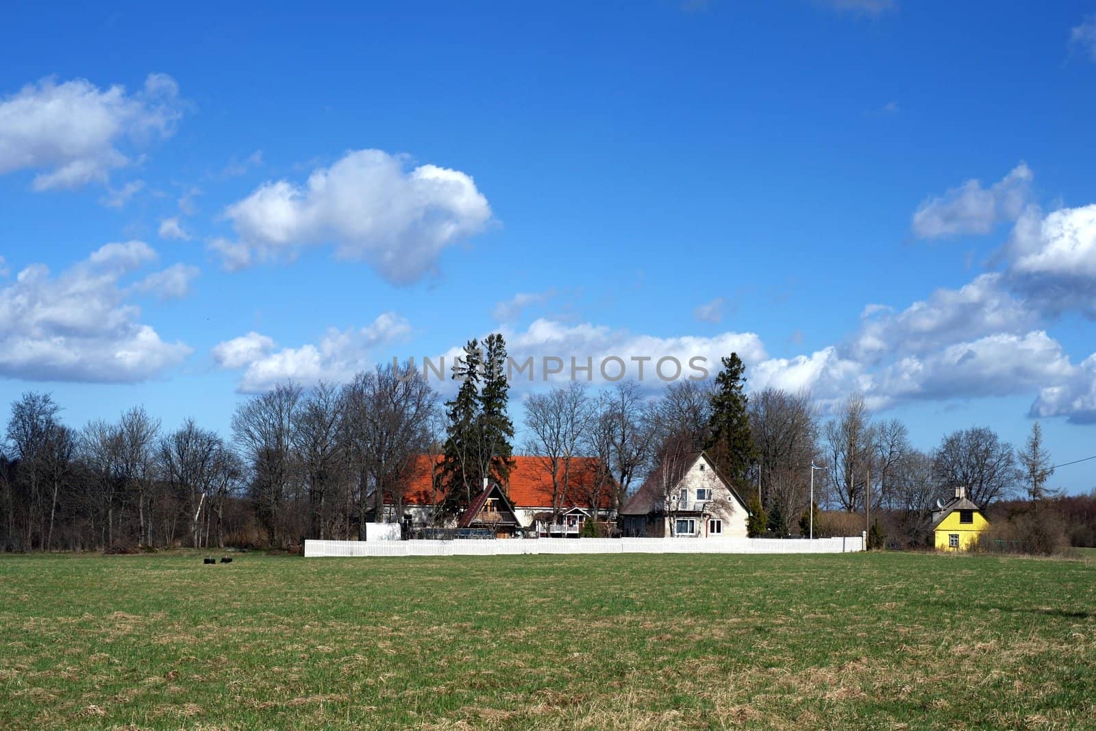 Country house on a background of the blue sky and clouds