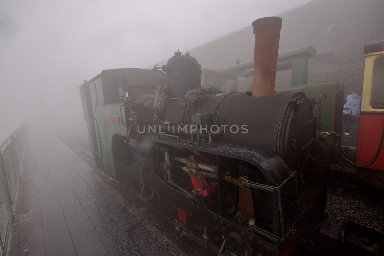 Famous tourist attraction, small funicular steam loco on the top of Snowdon mountain in Wales, UK