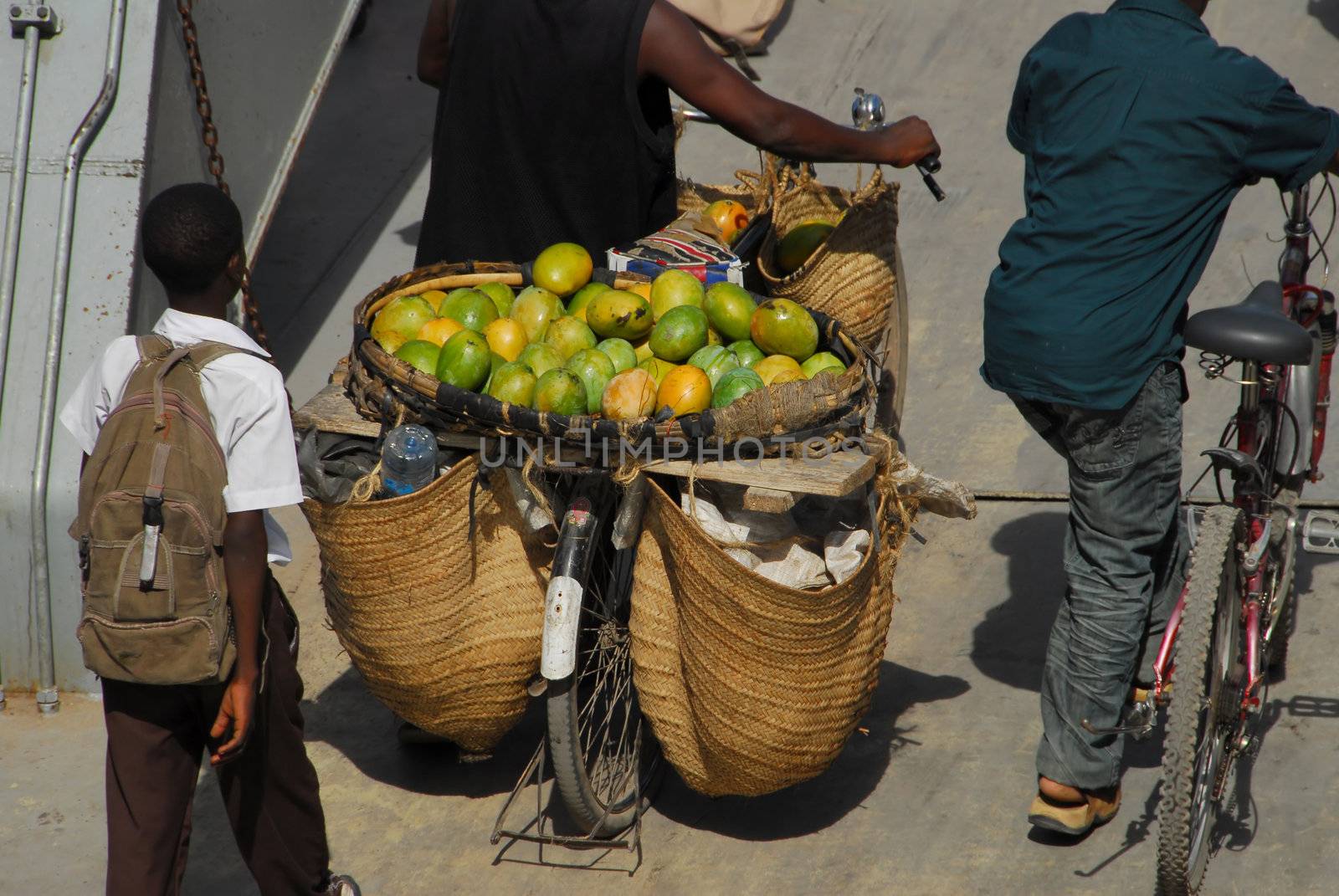 Dar es Salaam, Tanzania in July 2010: peddlers with their wares of fruit go down to the ferry that goes from Dar es Salaam to Kigamboni