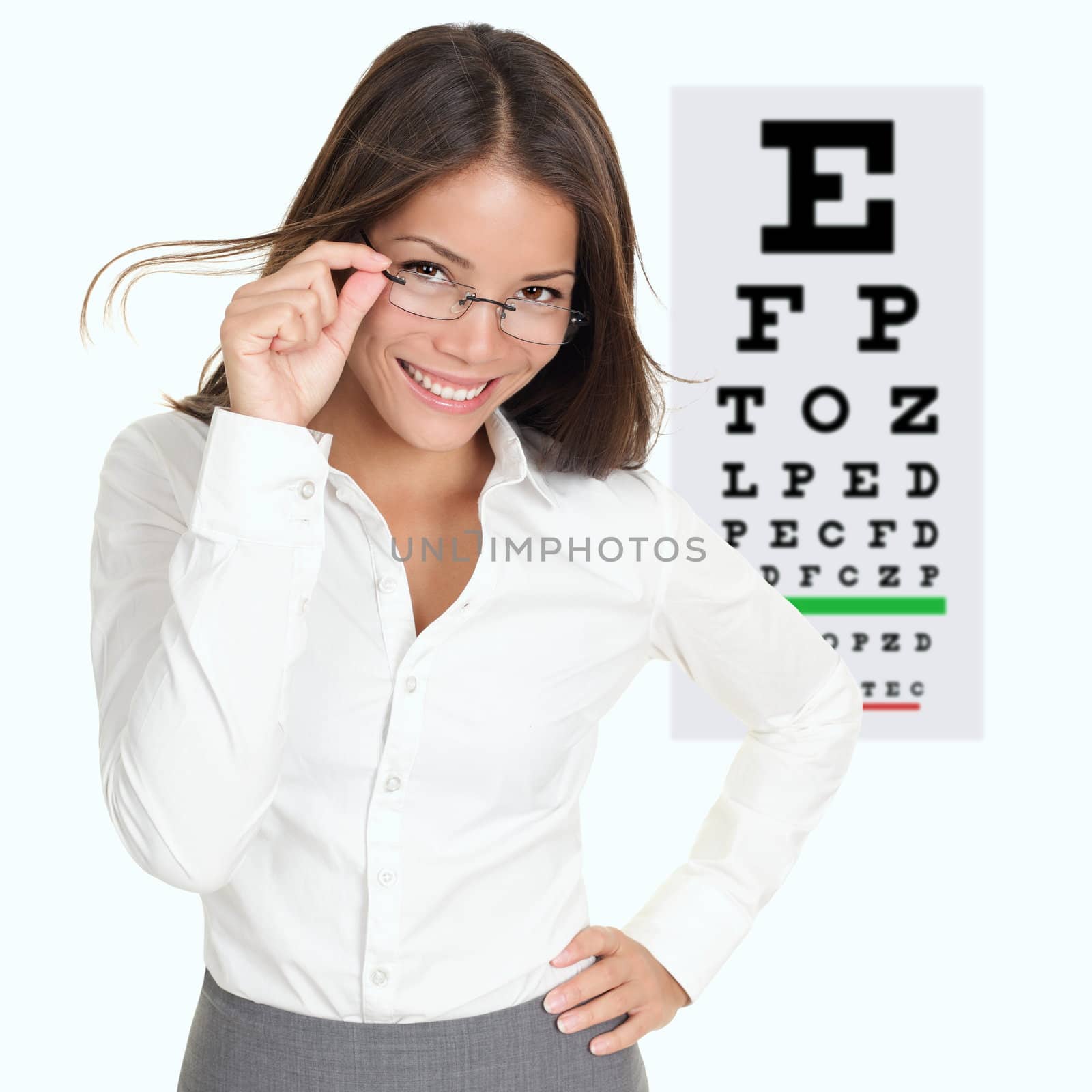 Optician or optometrist showing Snellen eye exam chart wearing eye wear glasses. Female mixed race Caucasian / Asian Chinese model