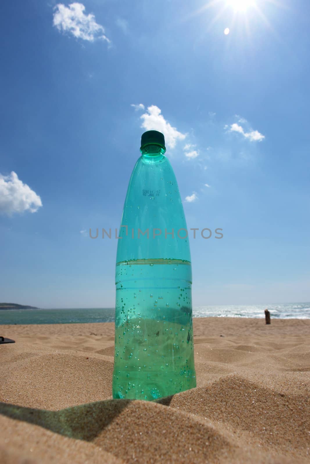 water bottle at the beach on a hot day