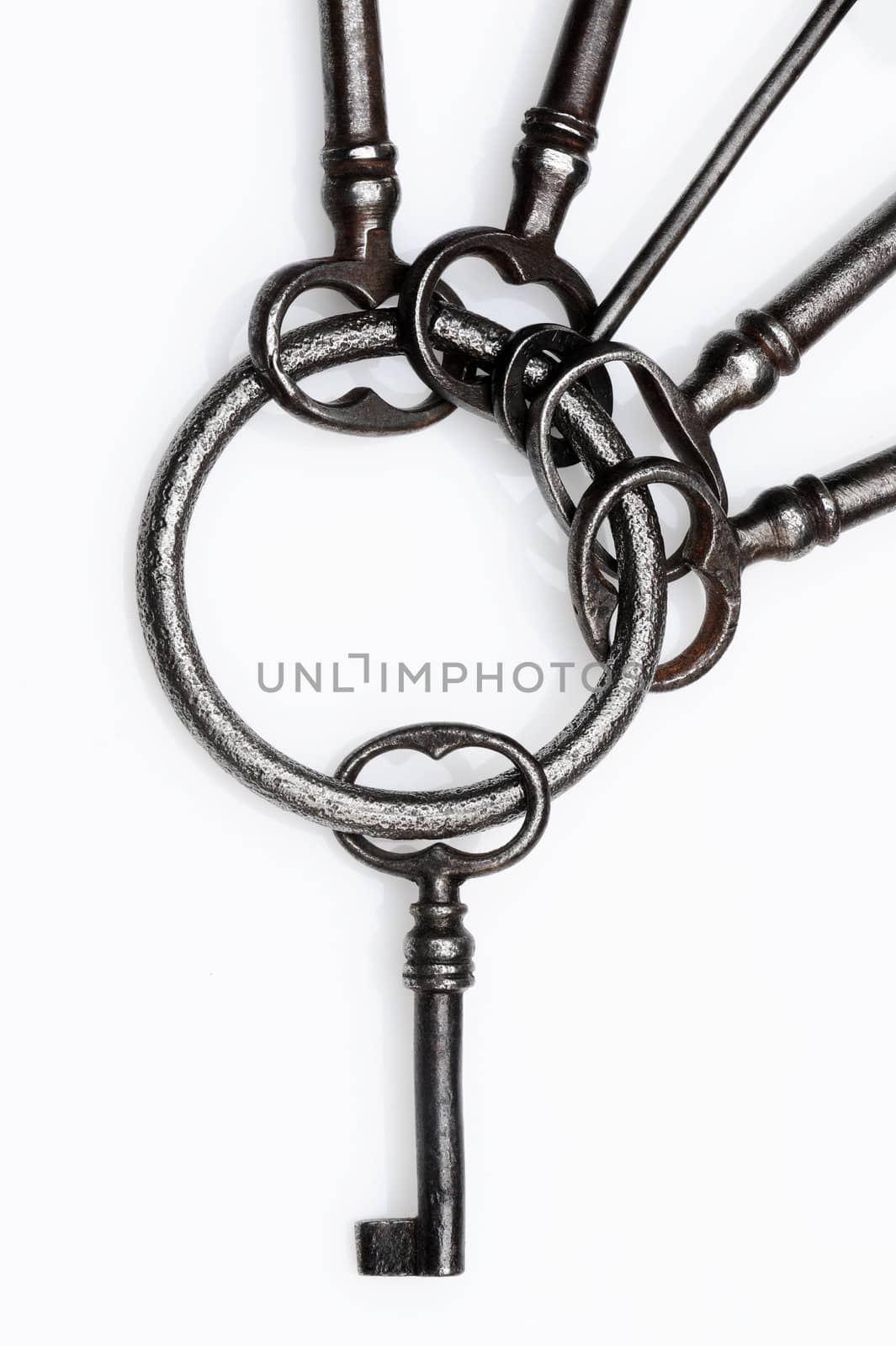 old keys on white background, close-up by stokkete