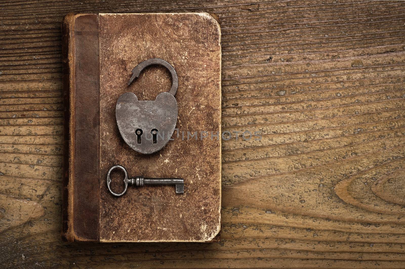 Antique Padlock with key on old book