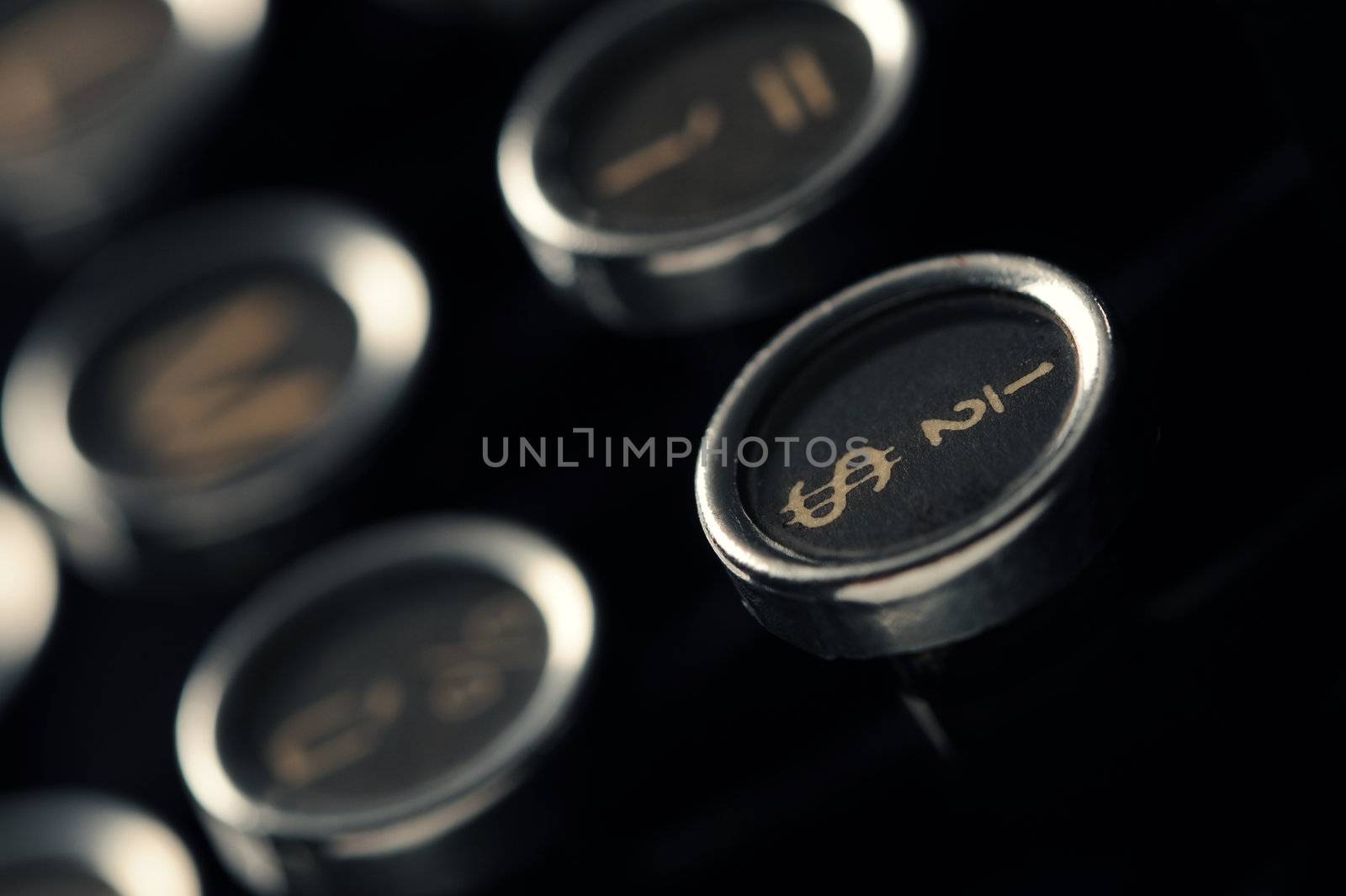 Close up photo of antique typewriter keys, shallow focus on dollar symbol