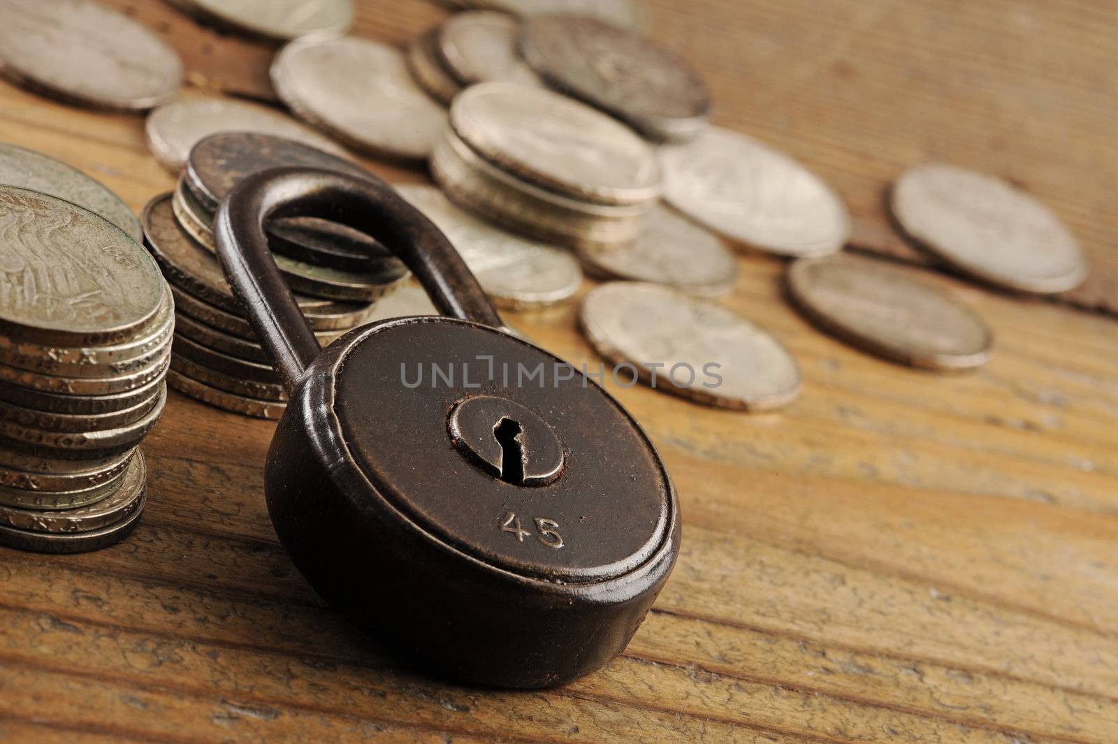 Old padlock close-up.coins on background