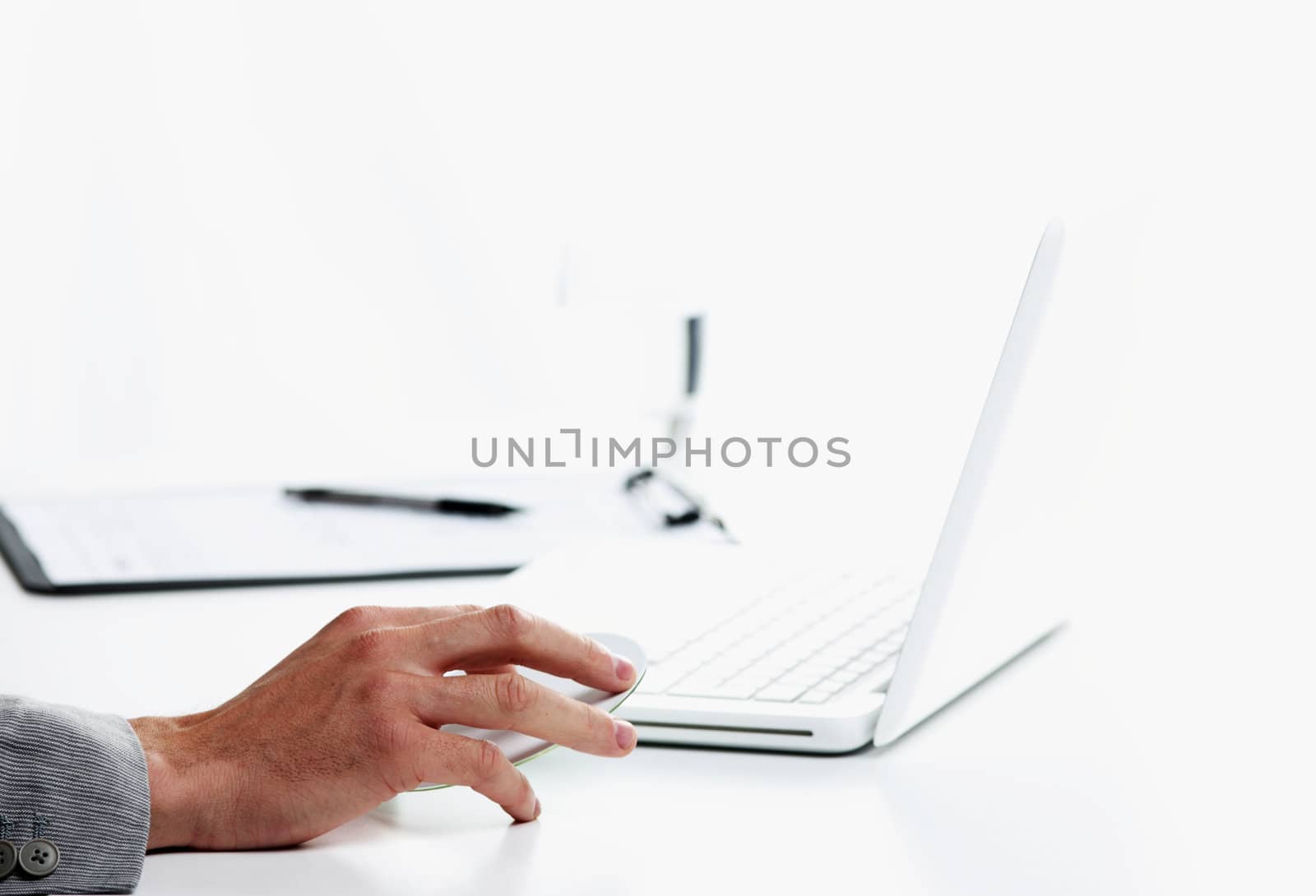 Businessman inserting a cd on white laptop by stokkete