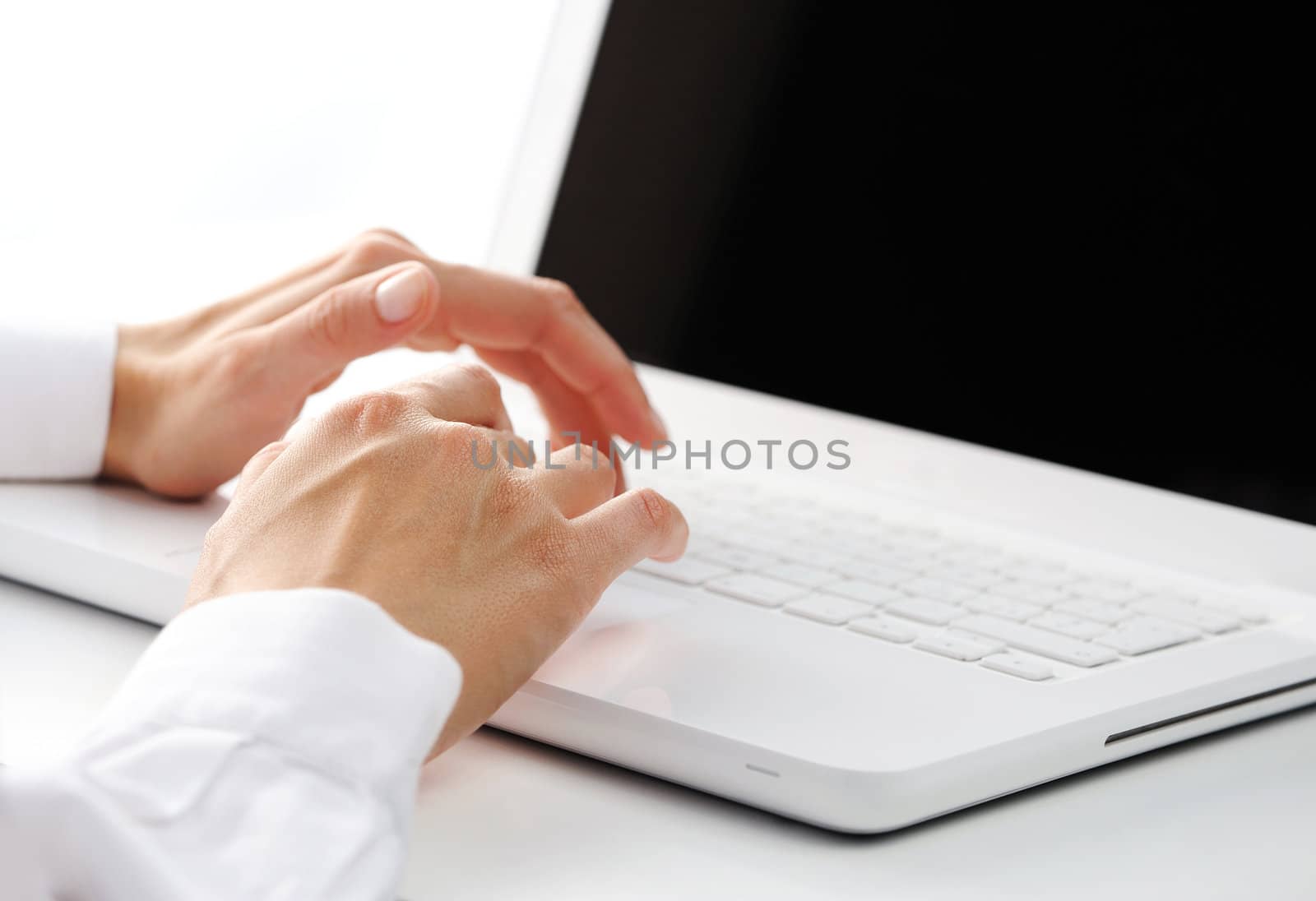 Businesswoman working at laptop computer with blank screen 