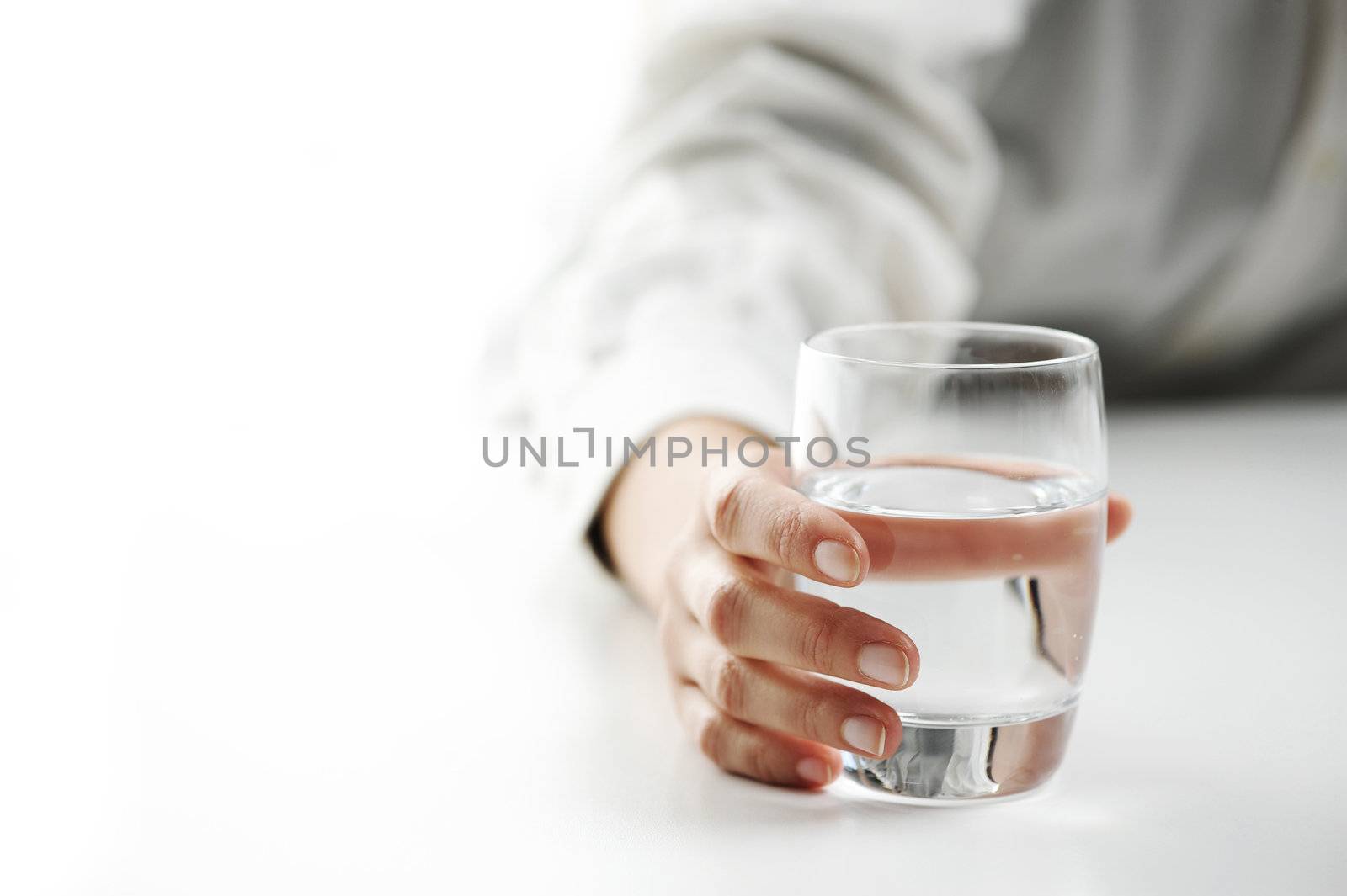 Close-up of a female hand with a glass of water