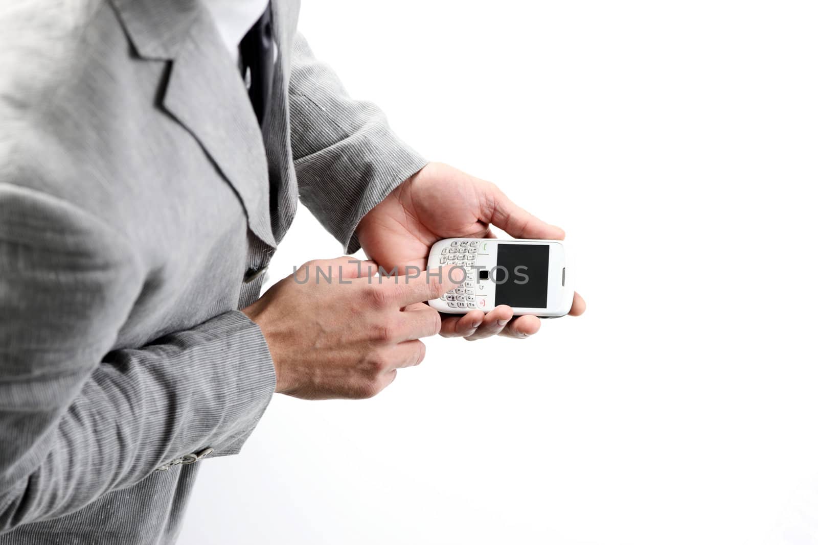 top view of a businesman's hands with a smart phone by stokkete