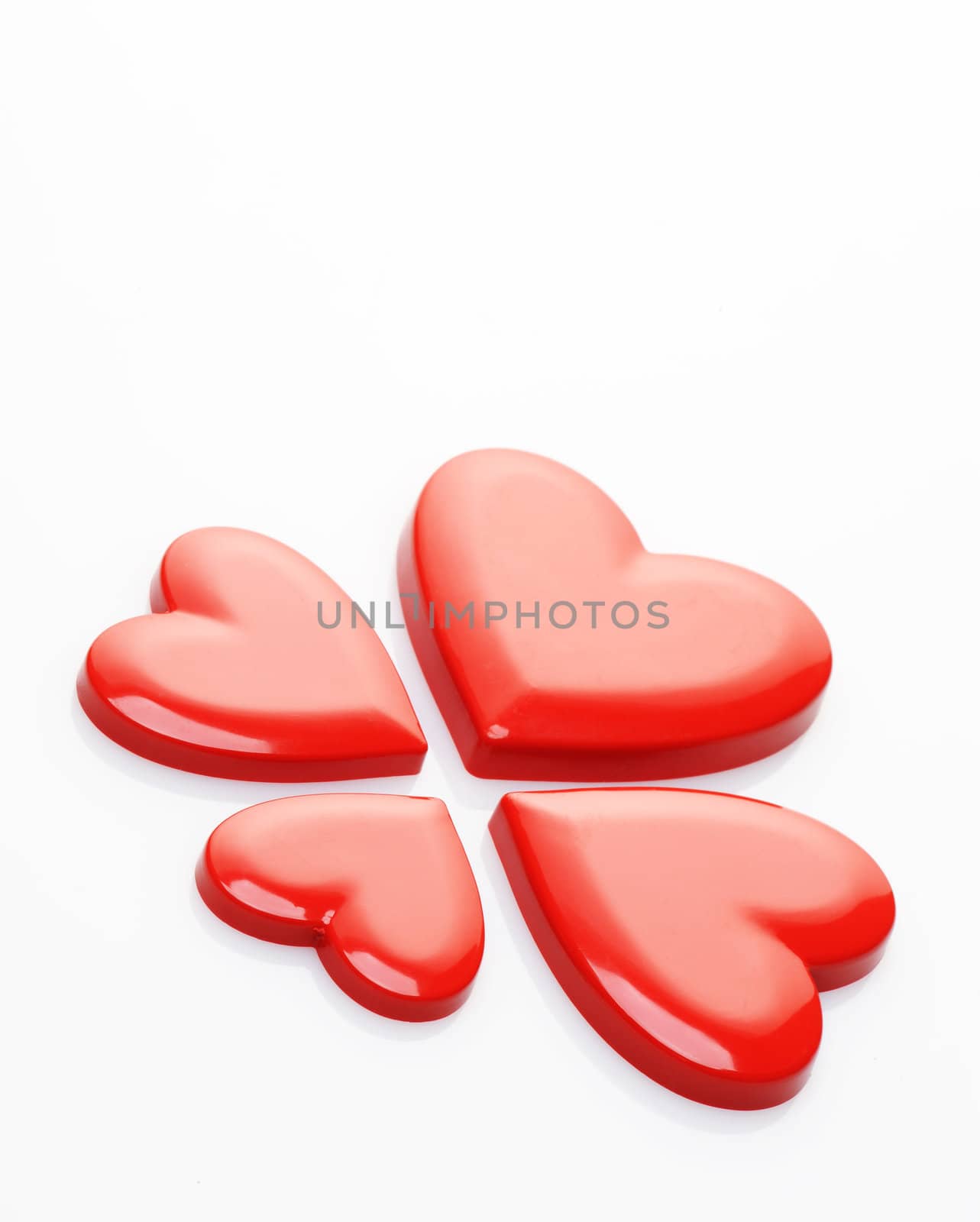 red hearts on white background by stokkete