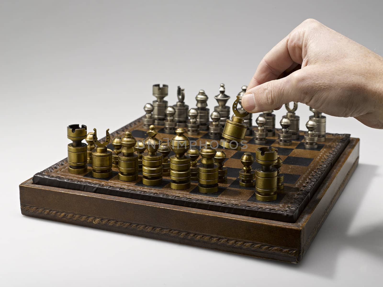 A chess player making his next chess move by pbombaert