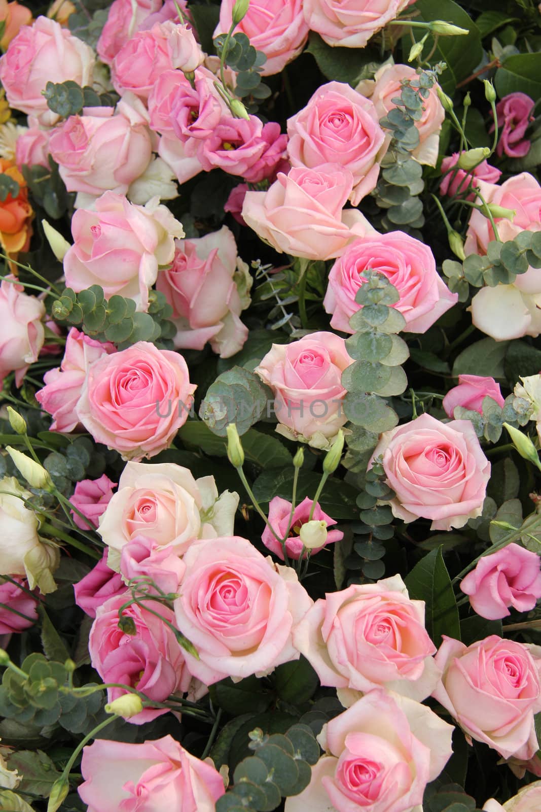 Lisianthus and roses in a pink wedding centerpiece