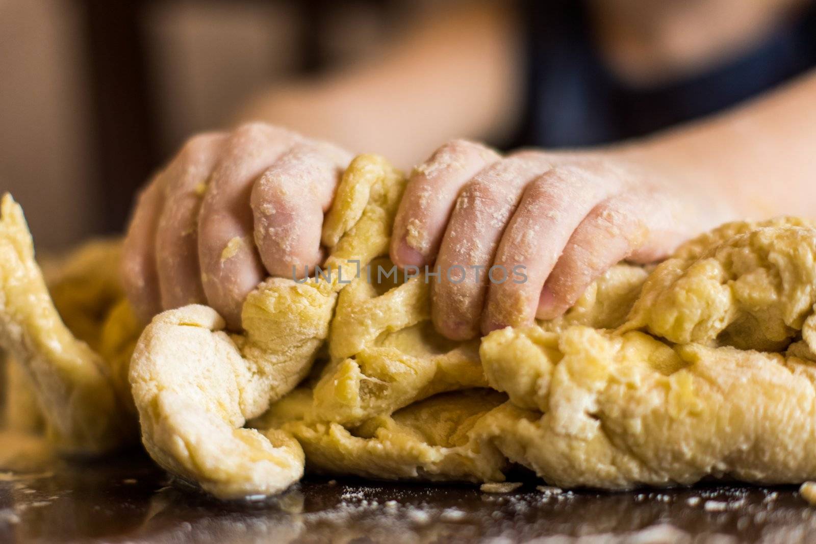 children's hands diligently preparing bread