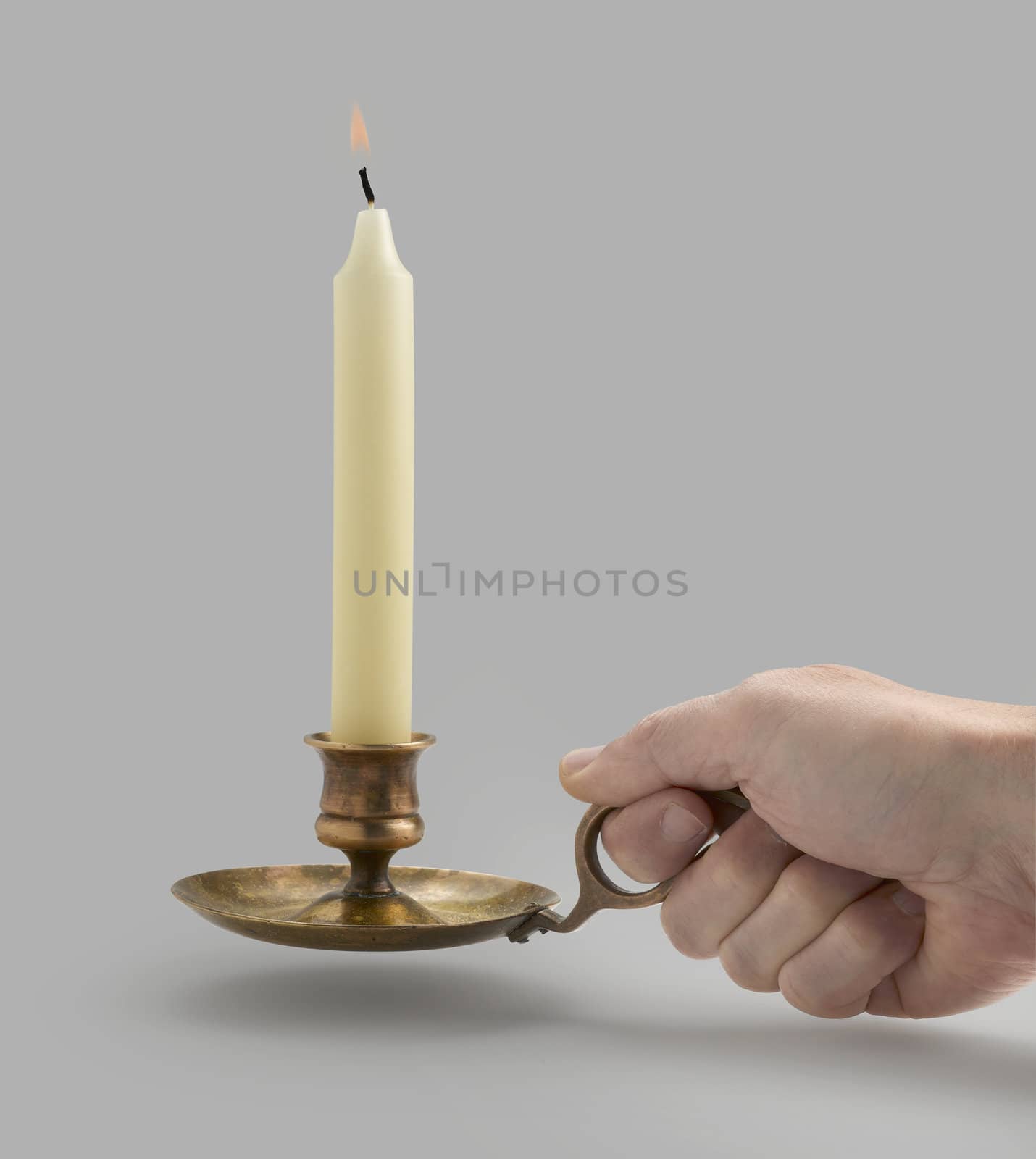 Candlestick with flame lights and hand (clipping path)