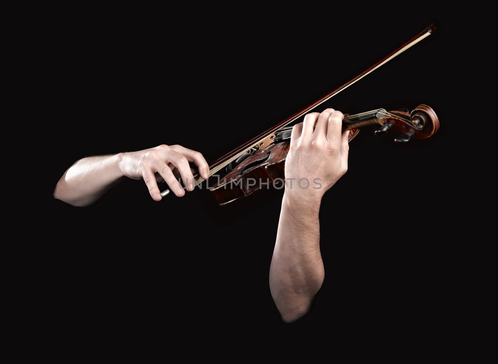 Hands playing  wooden violin on black background