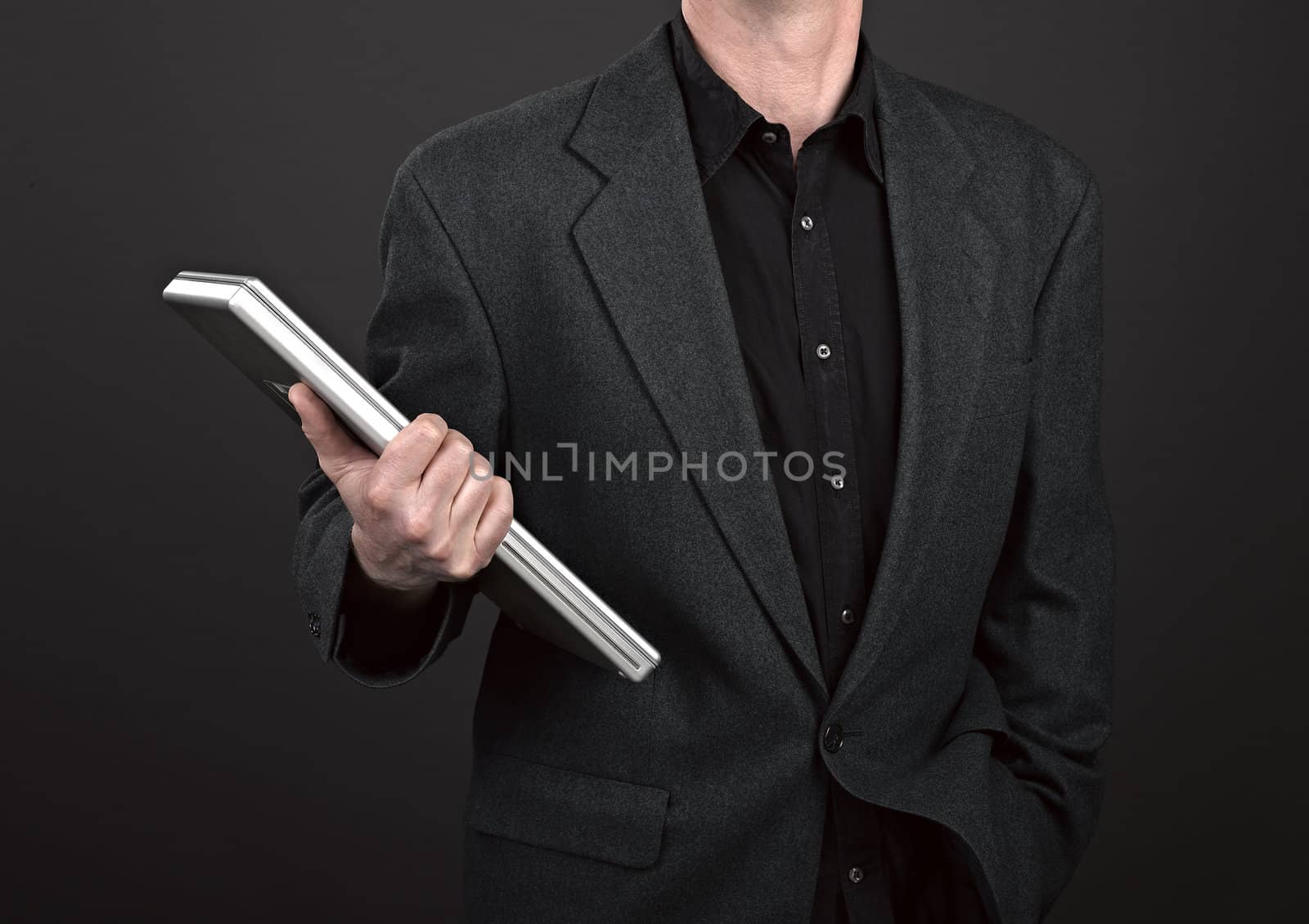 Businessman holding his laptop on black