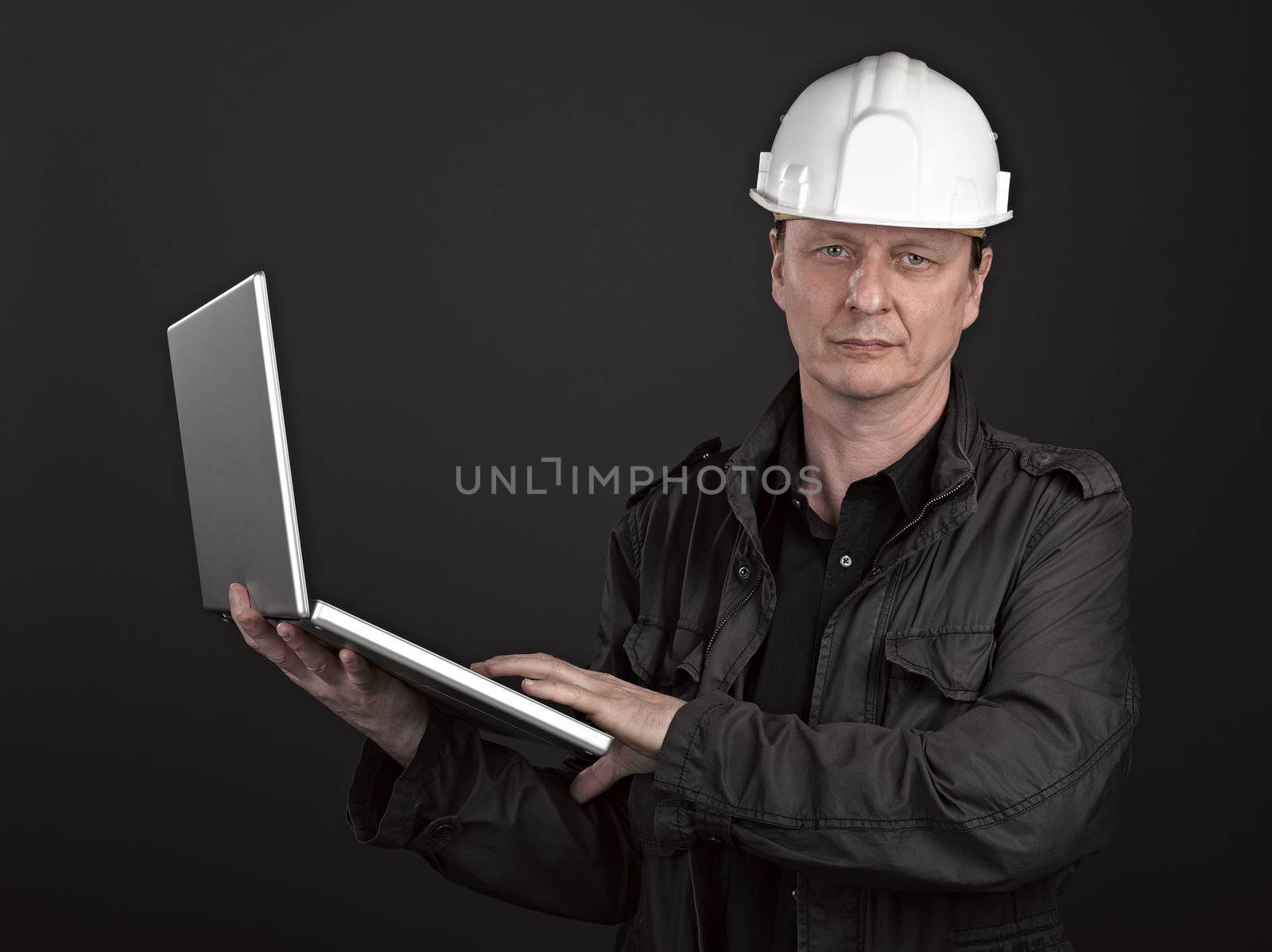 Portrait of man architect on black background