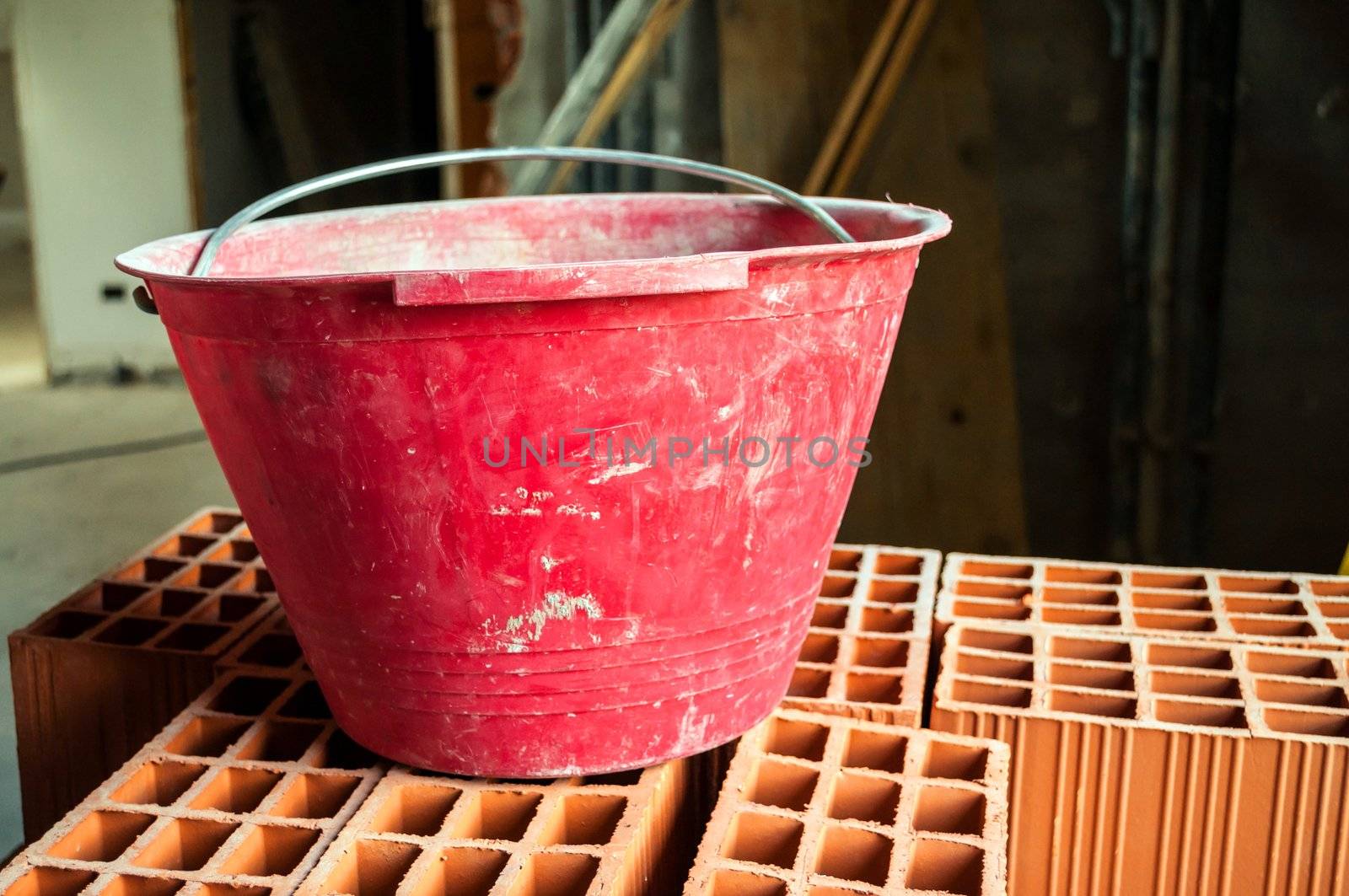 Masonry bucket on hollow bricks in construction site