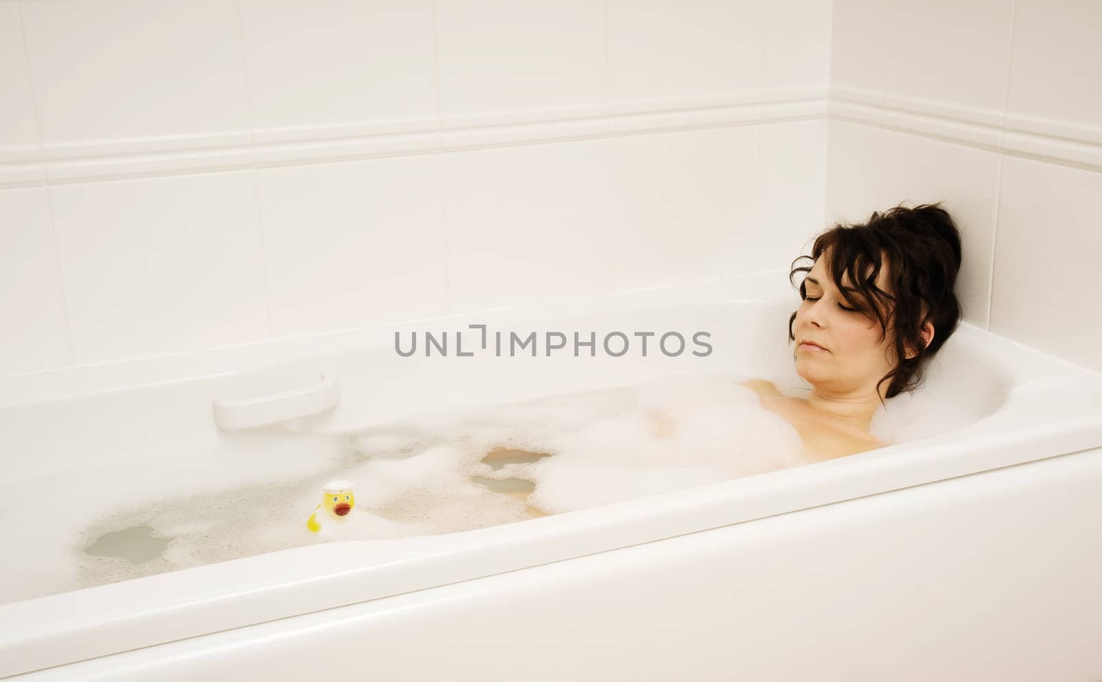 woman in bath with rubber duck