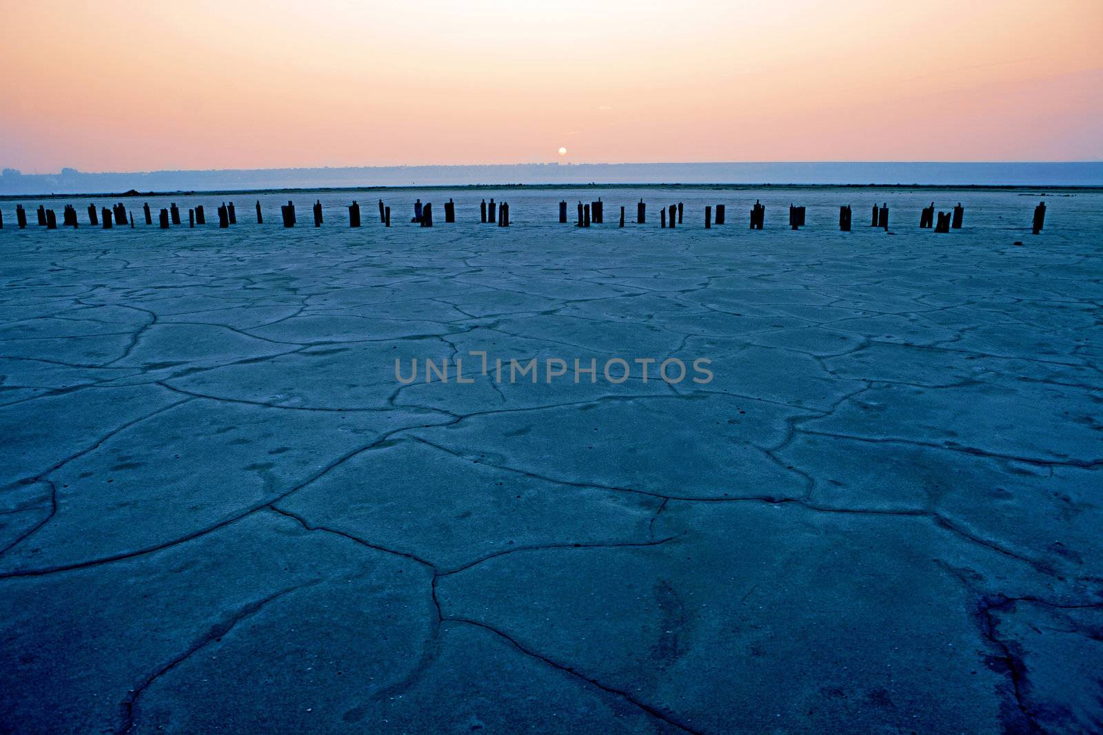 Dried-up salt lake at sunset at Kuyalnik lake