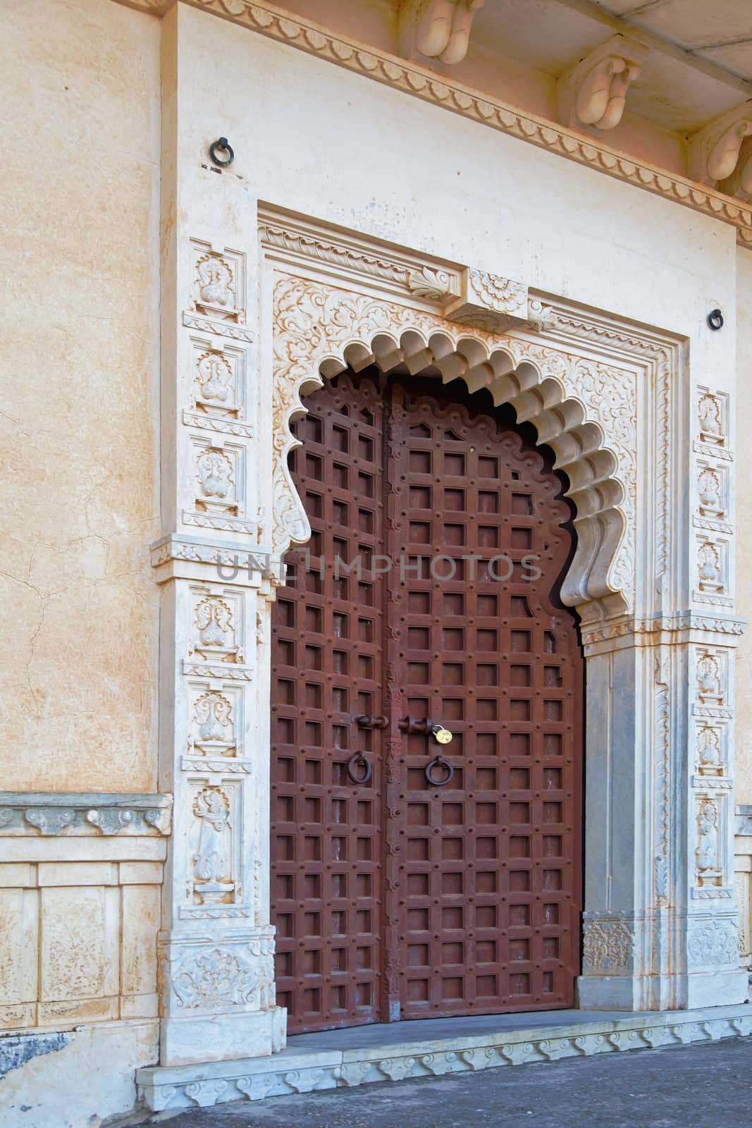 Large reinforced doorway inside the palace grounds at Kumbhalghar Fort with unusual door closure and stone masonry surround