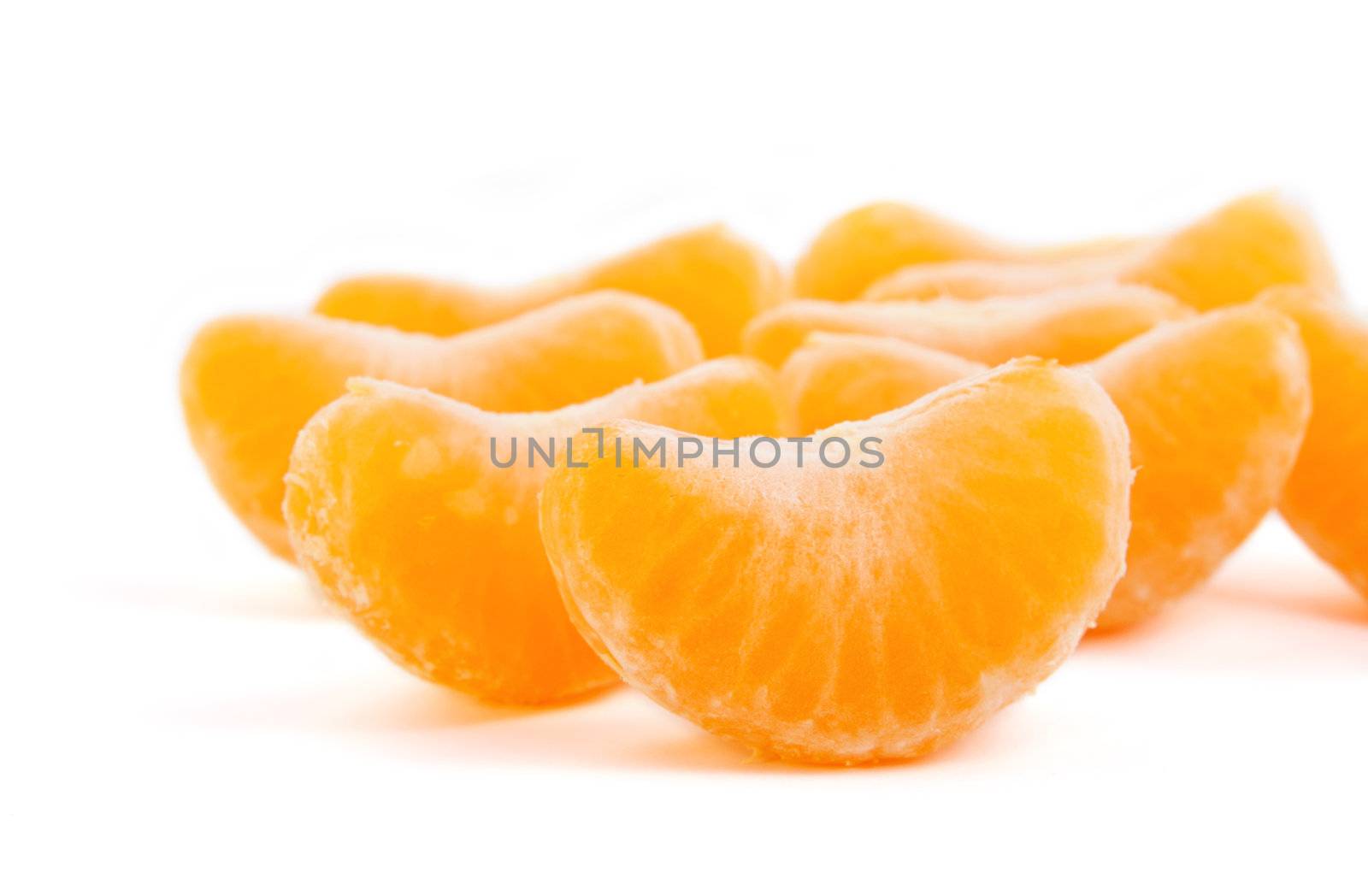 Fresh slices of mandarin on white isolated fone