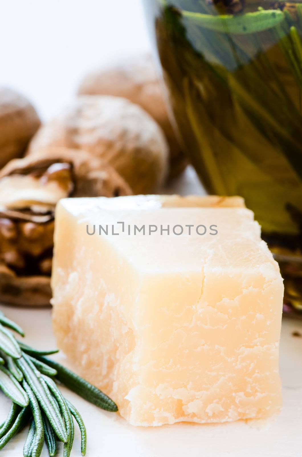 Parmesan and olive oil with nuts and rosmary on background