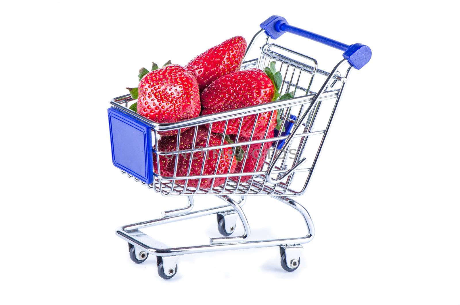 Miniature shopping cart filled up with strawberries