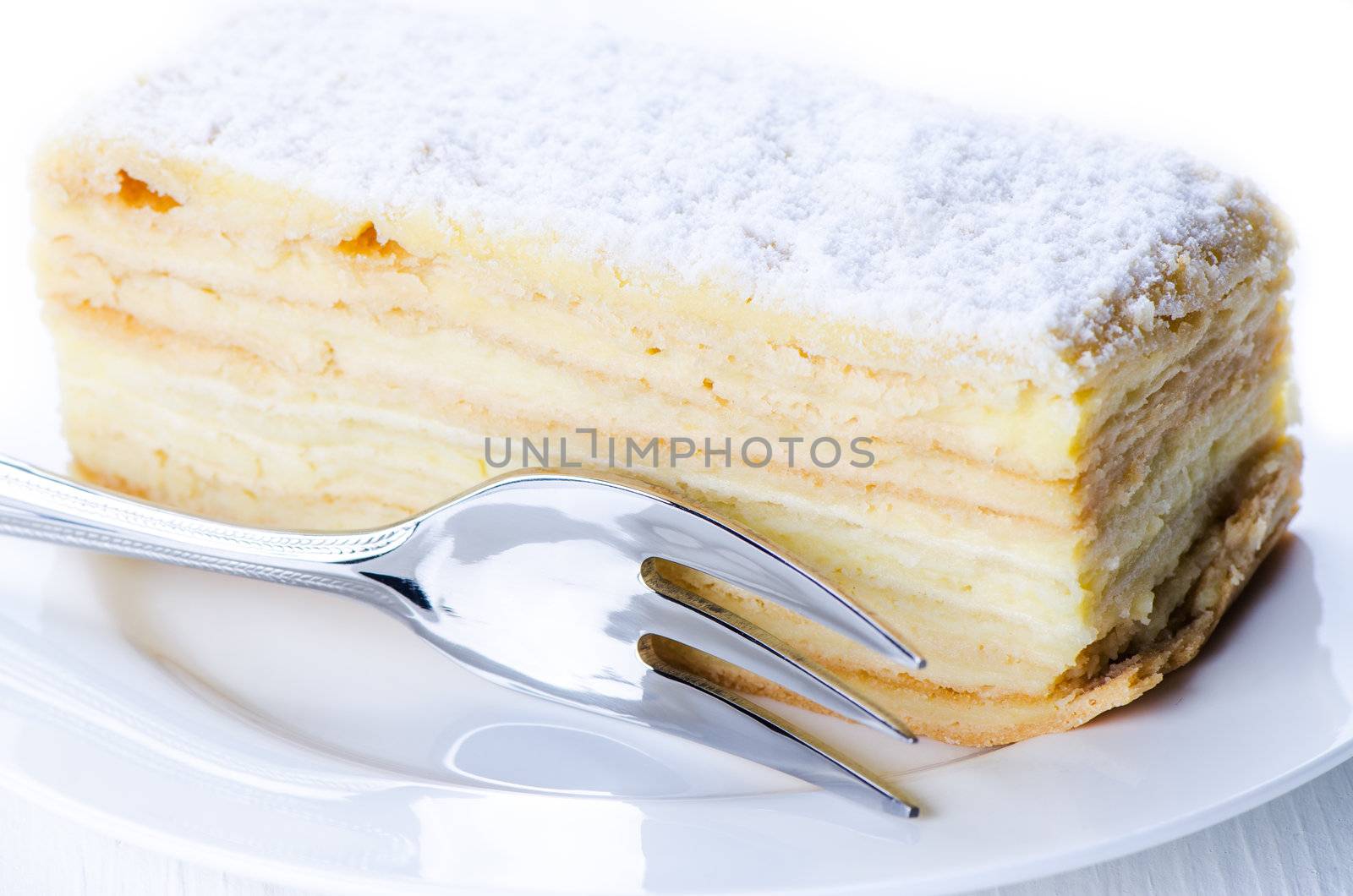 Napoleon cake on a plate with desert fork