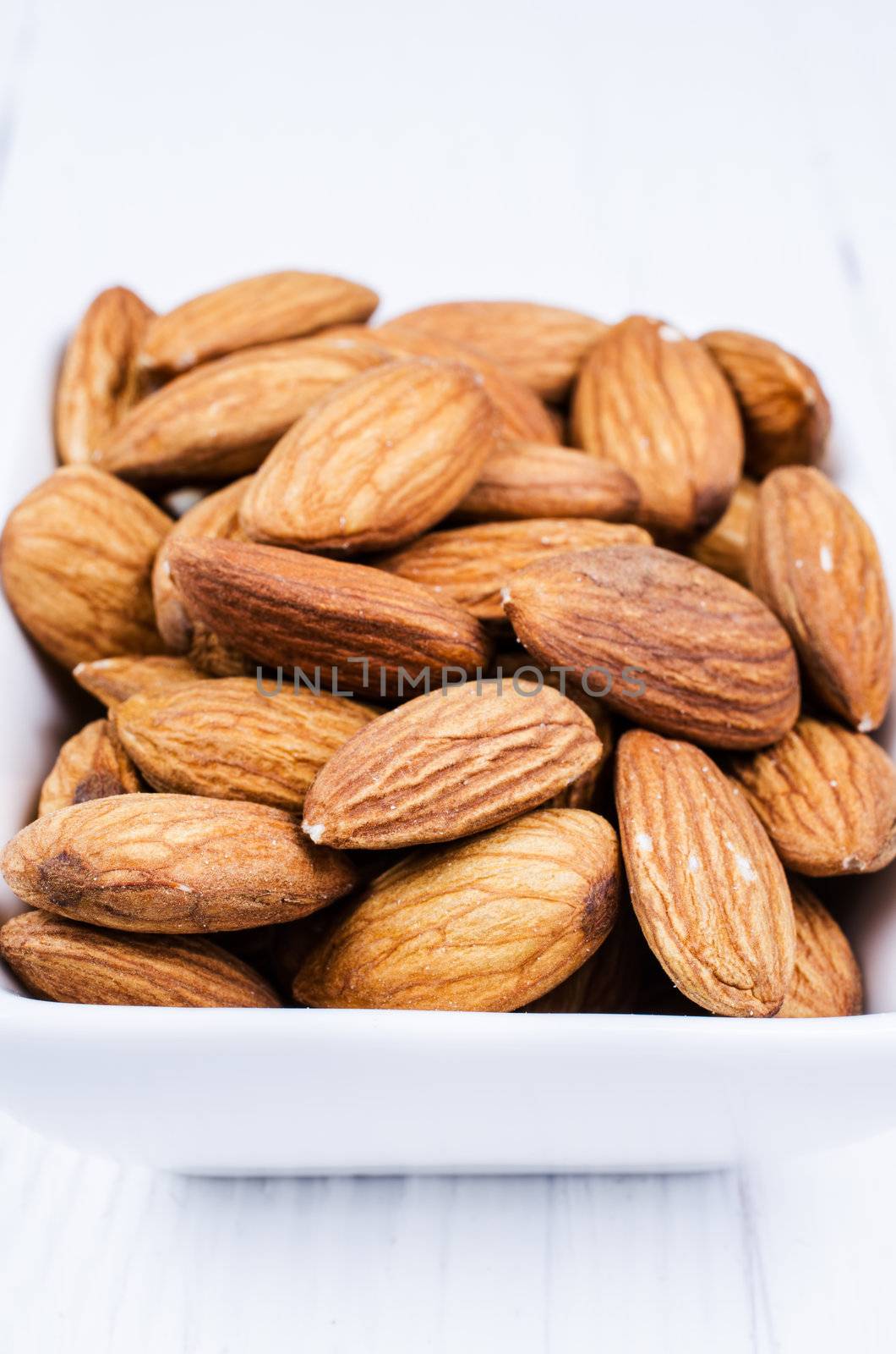 Almonds in a bowl by Nanisimova