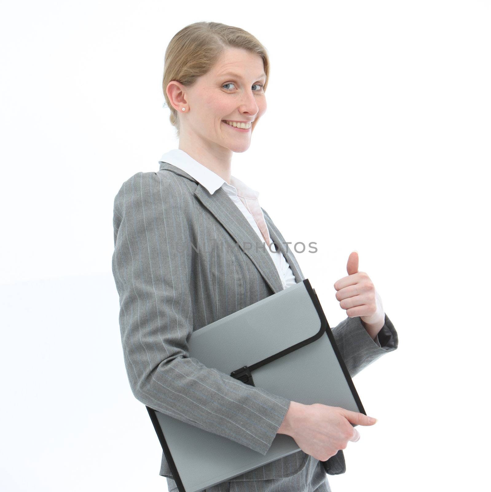 Motivated smiling professional woman in a fashionable jacket carrying a folio file giving a thumbs up