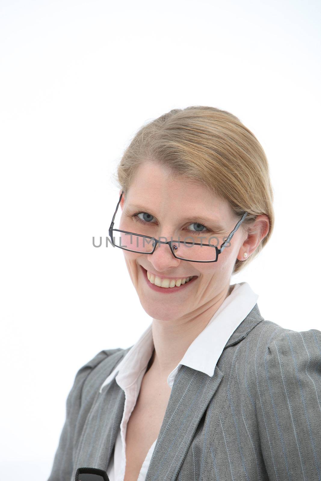 Happy woman peering over the top of her glasses with a lovely wide smile, isolated studio portrait