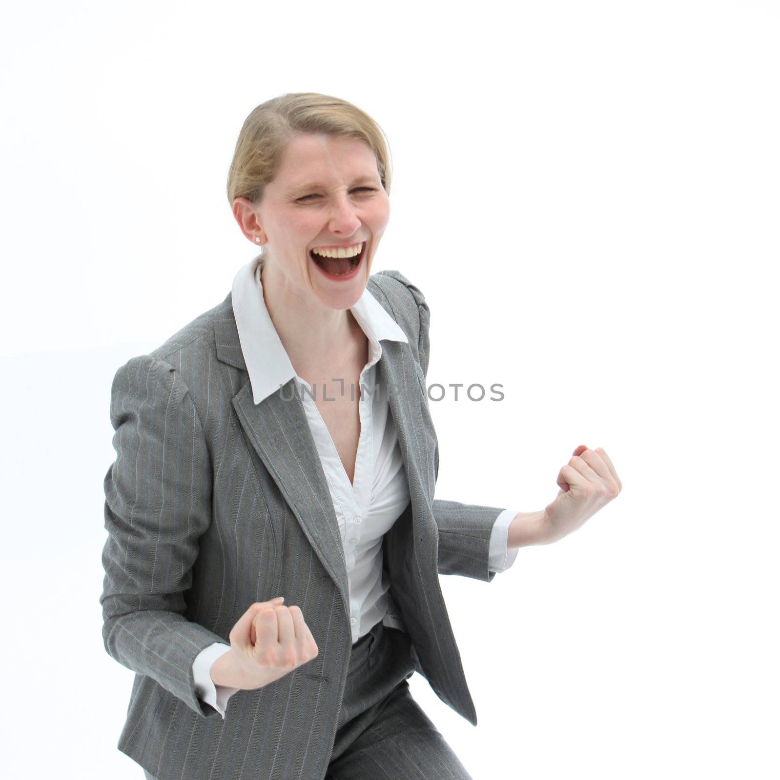 Ecstatic woman laughing and punching the air with her fists on receiving good news of her success