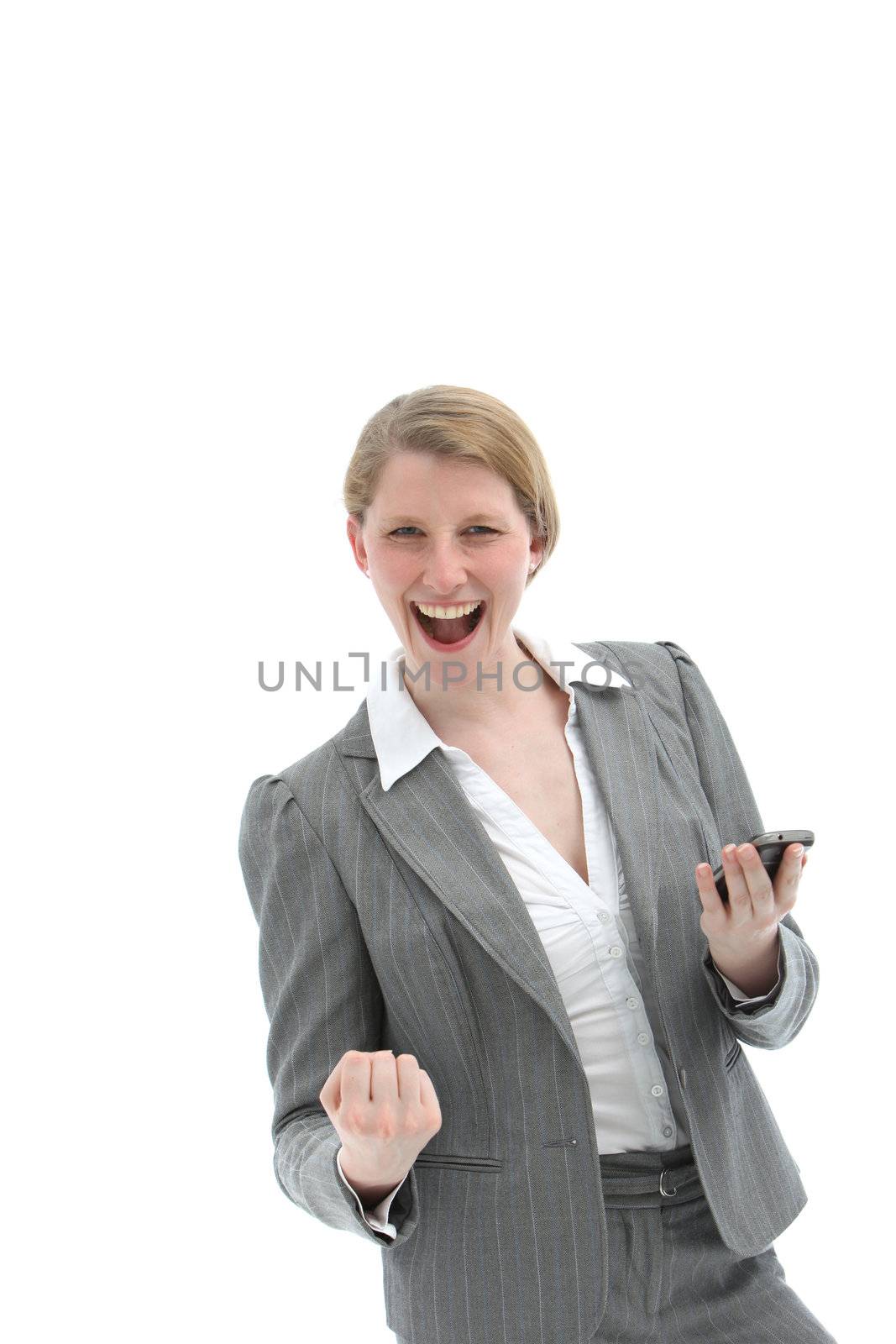 Woman laughing and punching the air with her fist after receiving good news on her mobile phone which she is holding in her hand