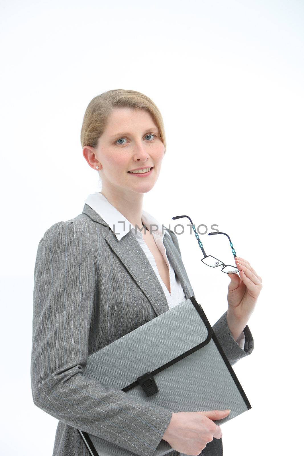 Dedicated secretary or personal assistant in stylish jacket holding glasses and a folio file