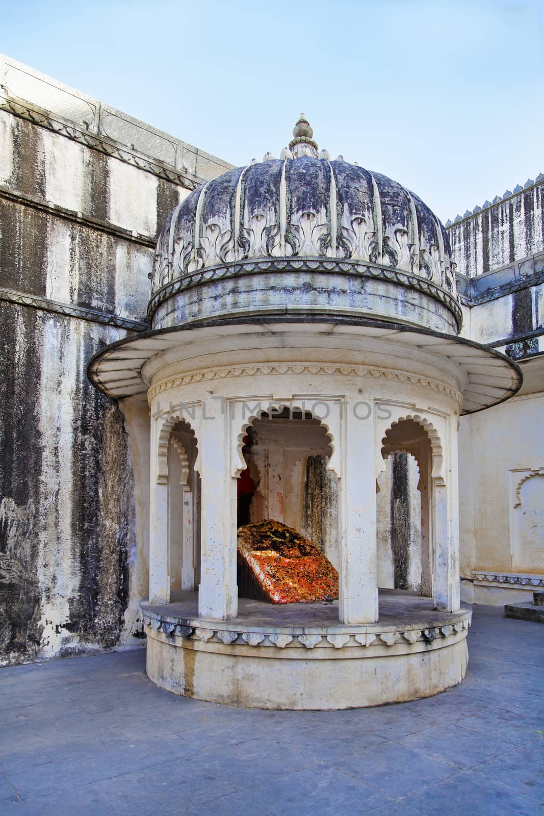 Vertical shot of a place of worship for hindus set in a corner of the royal living quarters of Kumbhalgarth Fort,  shivling in a domed building with pillars representing architecture from the 9th Century AD